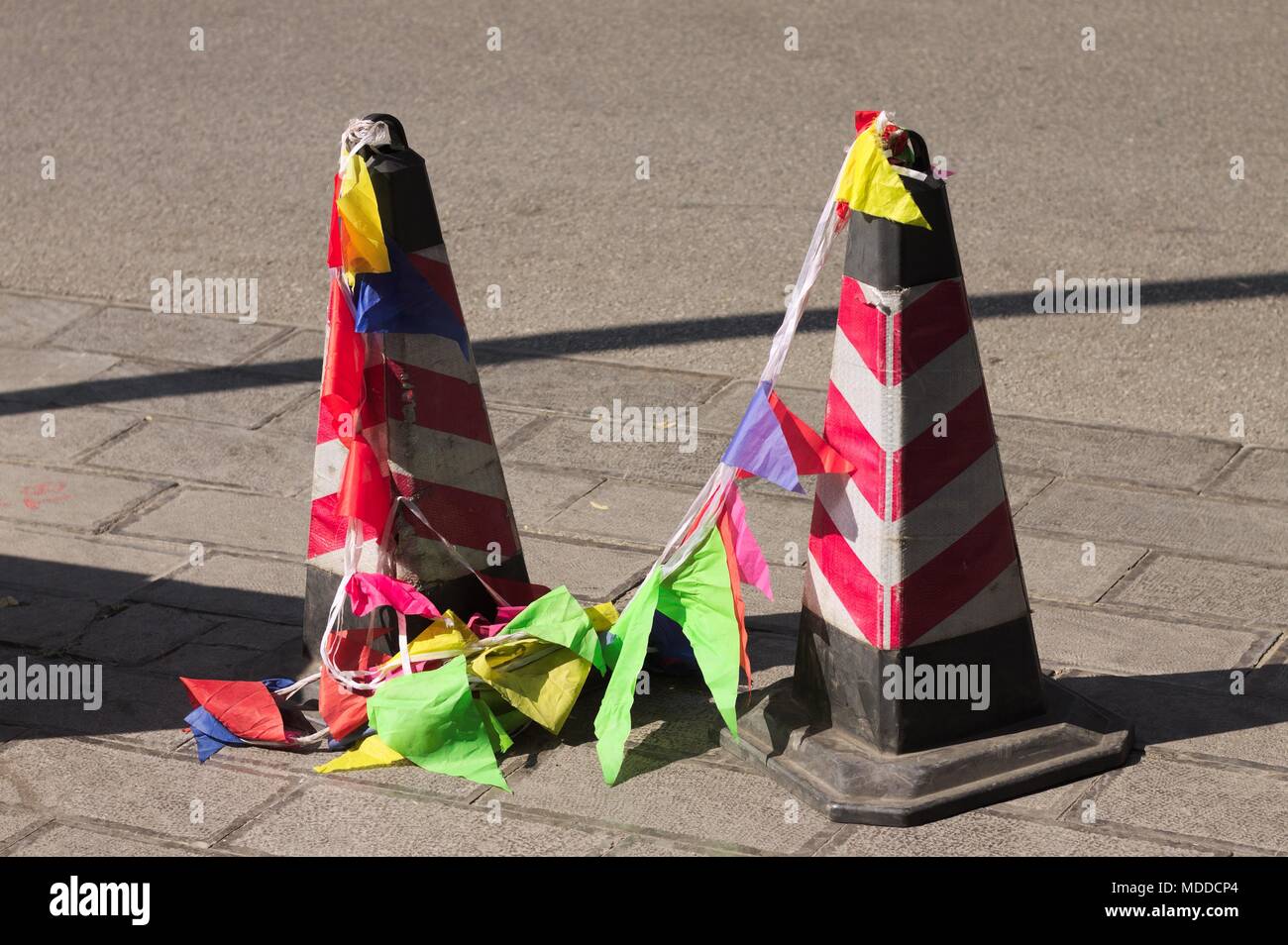 Reflector traffic cones with colored flags on the street (Kunming