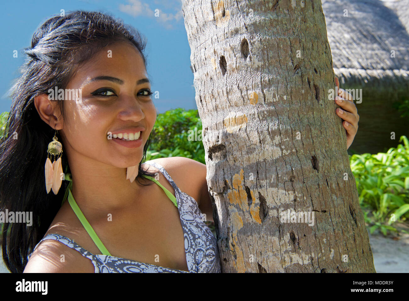 Girl and palm tree South Ari Atoll Maldives Stock Photo