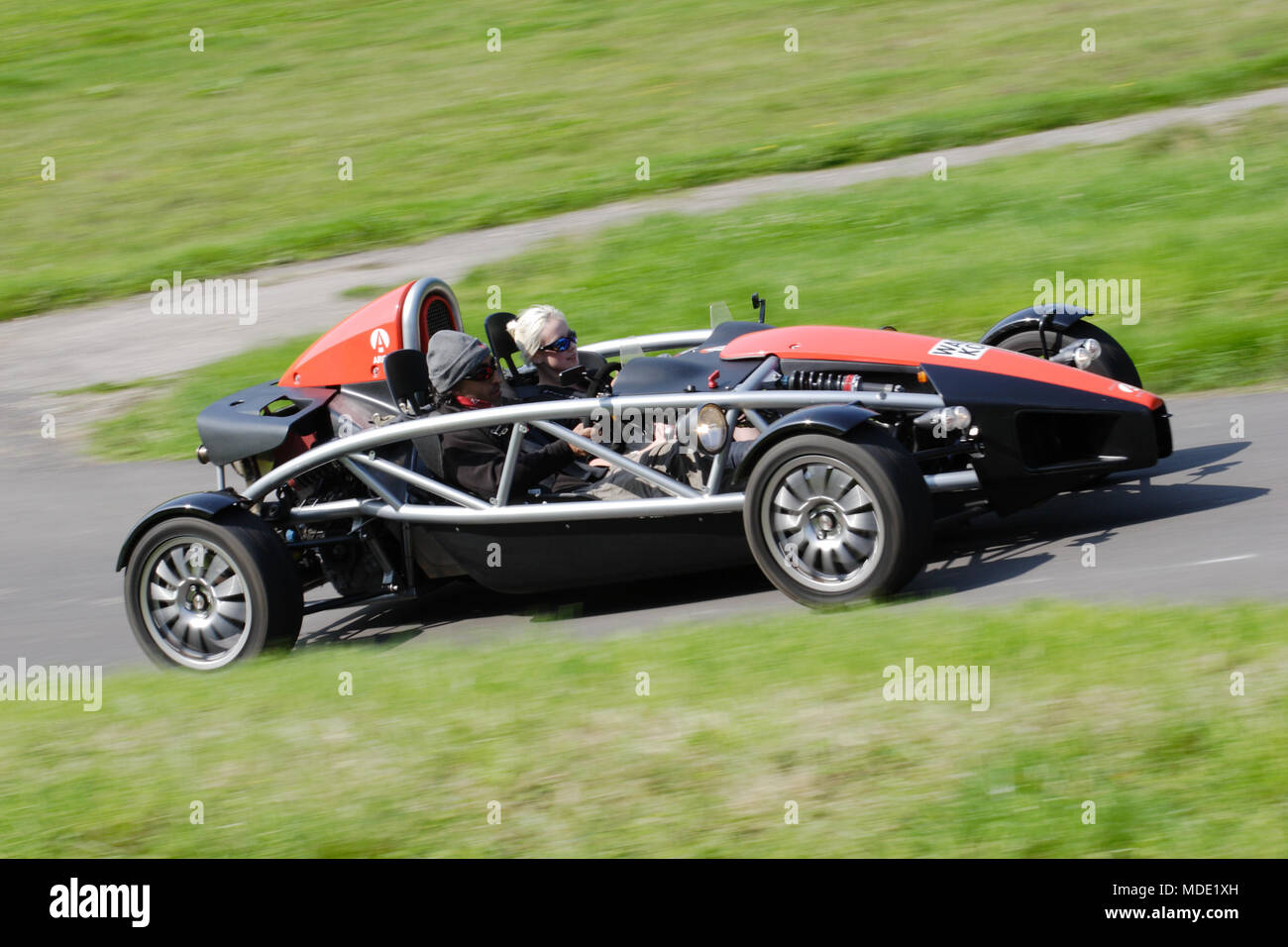 Ariel Atom lightweight sports car or track car driving fast on the UK public roads. Ariel Atoms have a visible car exoskeleton. Stock Photo