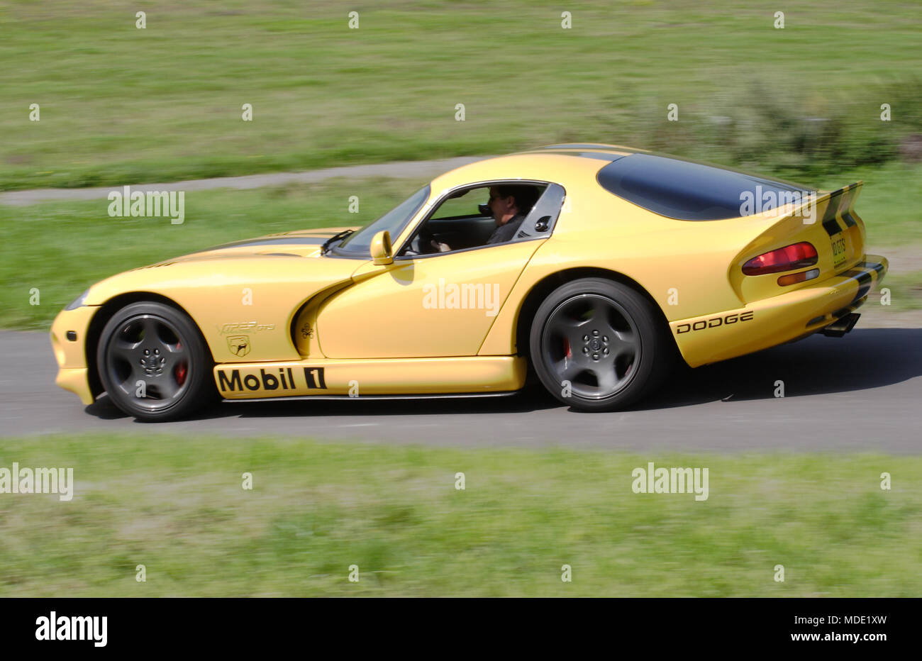 Yellow Dodge Viper GTS American sports car driving fast. Stock Photo