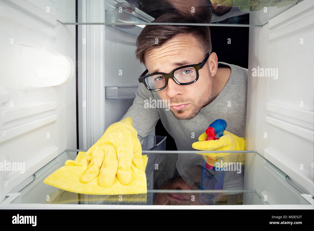 Man cleaning the fridge Stock Photo