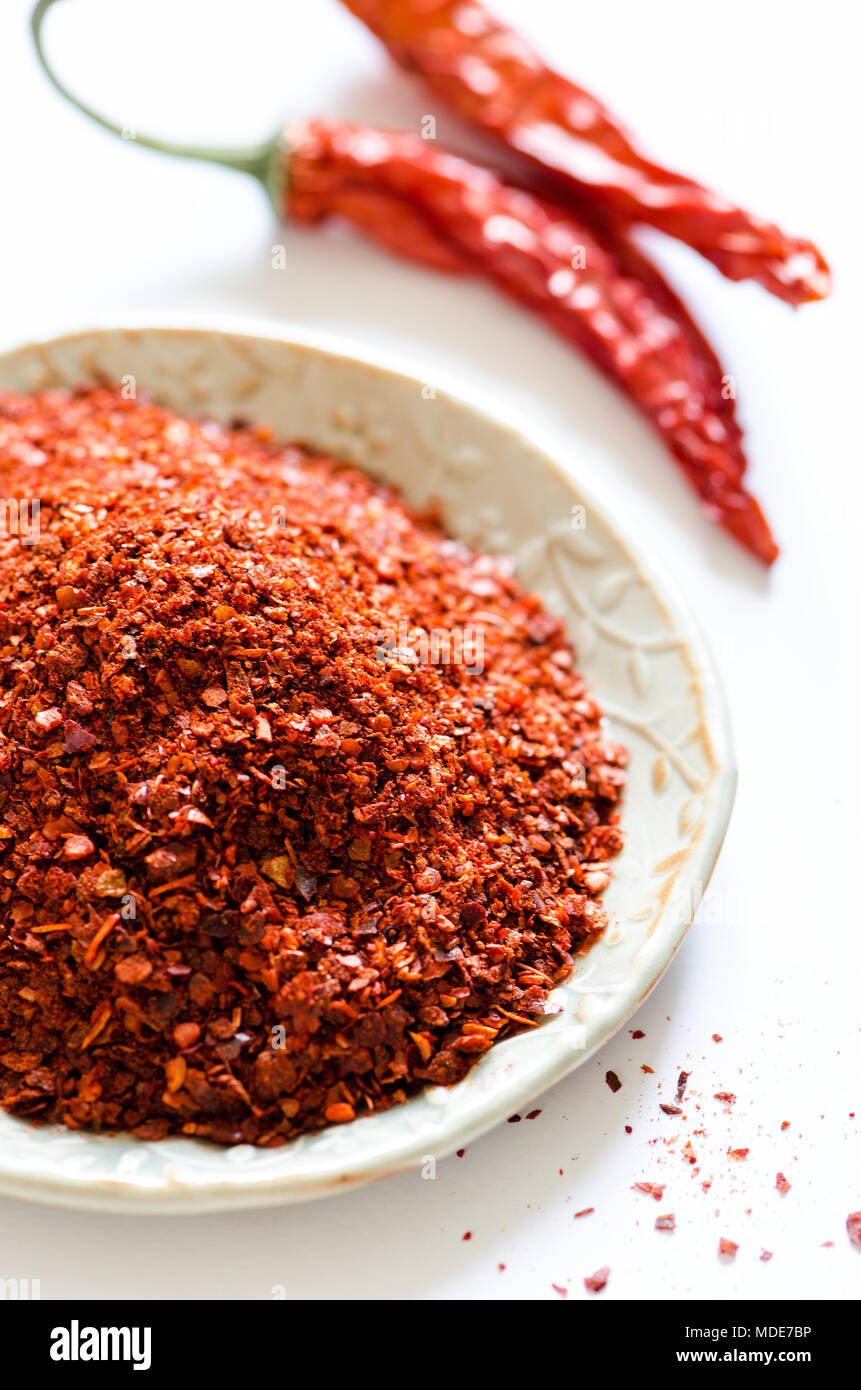 Paprika powder with red chili peppers on white background Stock Photo