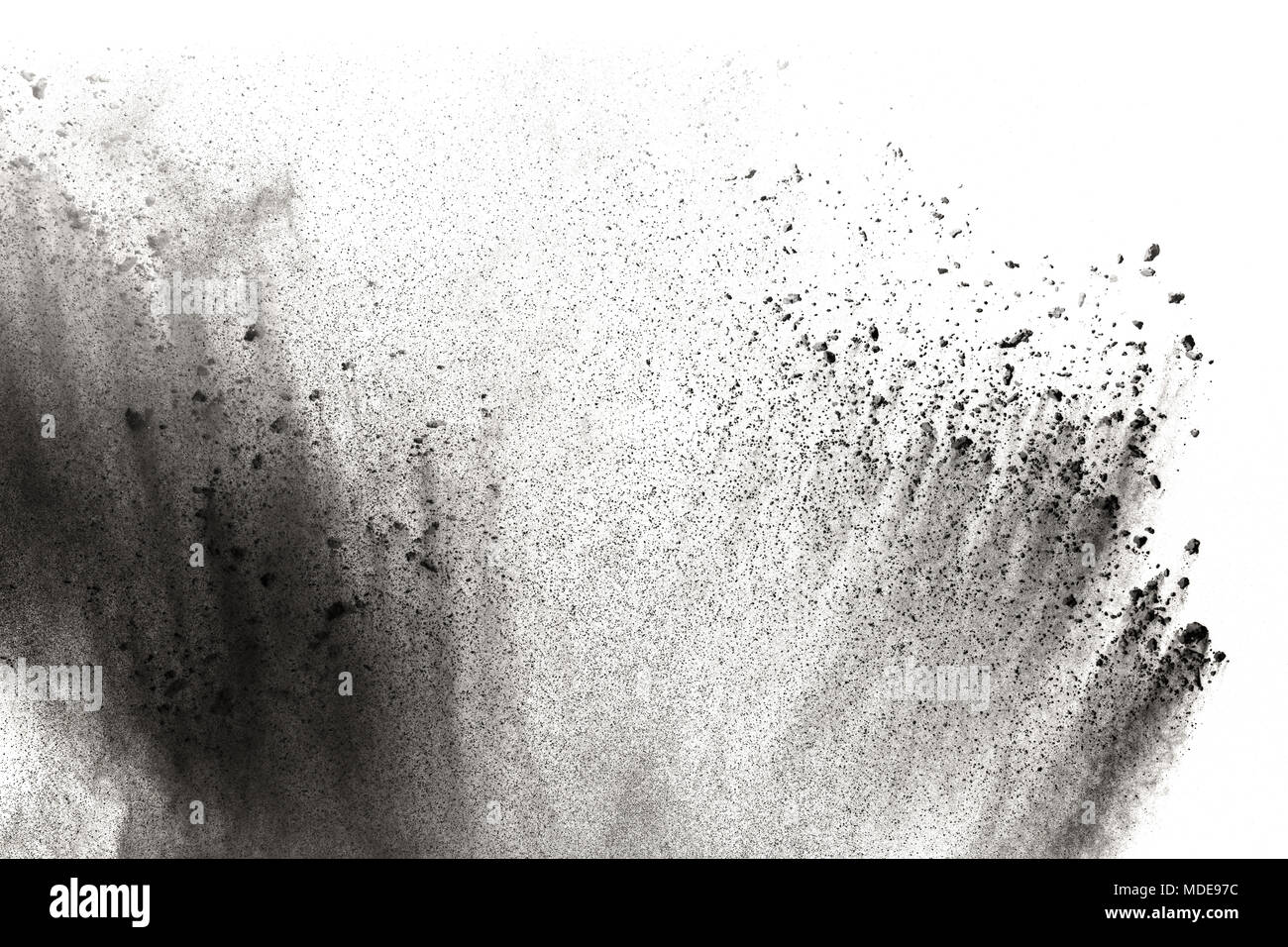 Black powder explosion against white background.The particles of ...
