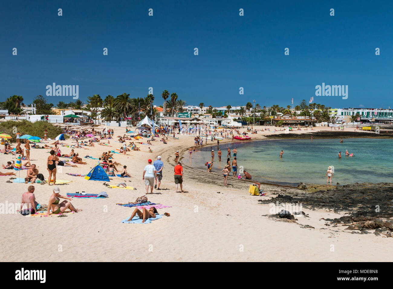 FUERTEVENTURA - SEPTEMBER 20: Tourists enjoying the day at a Corralejo City beach in Fuerteventura, Spain on September 20, 2015 Stock Photo
