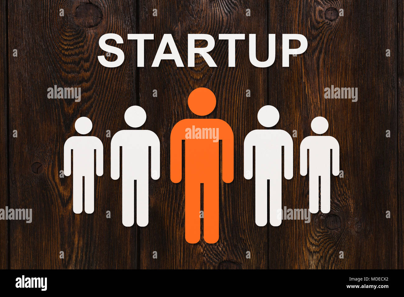 Business concept. Paper men on wooden background and text STURTUP. Abstract conceptual image Stock Photo
