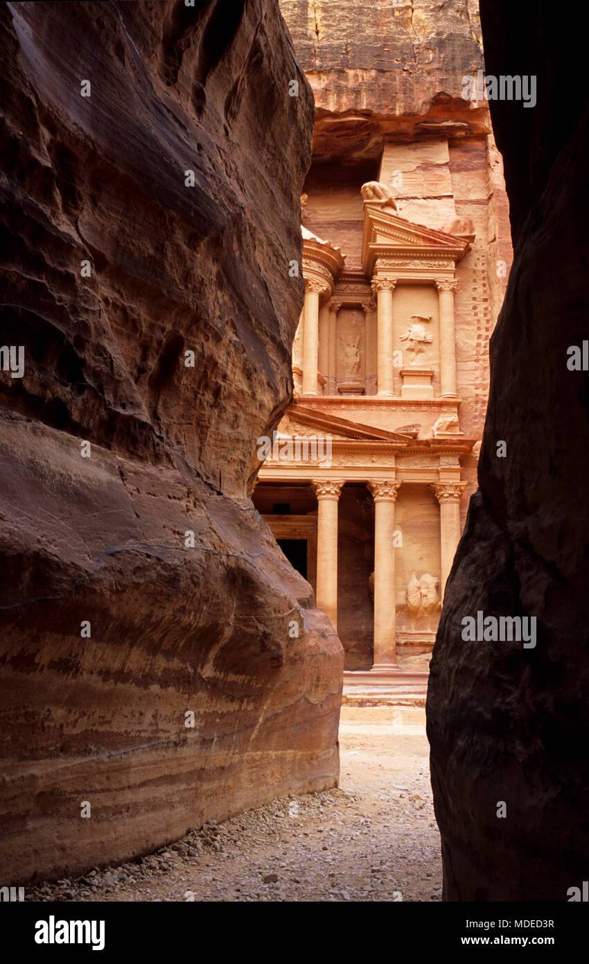 The Treasury viewed between Al Siq canyon walls of Petra, Jordan Stock Photo