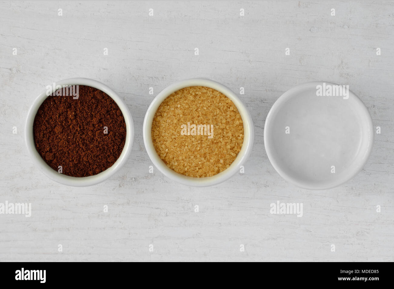 Homemade face scrub made out of coffee powder, brown sugar and coconut oil on wooden background Stock Photo