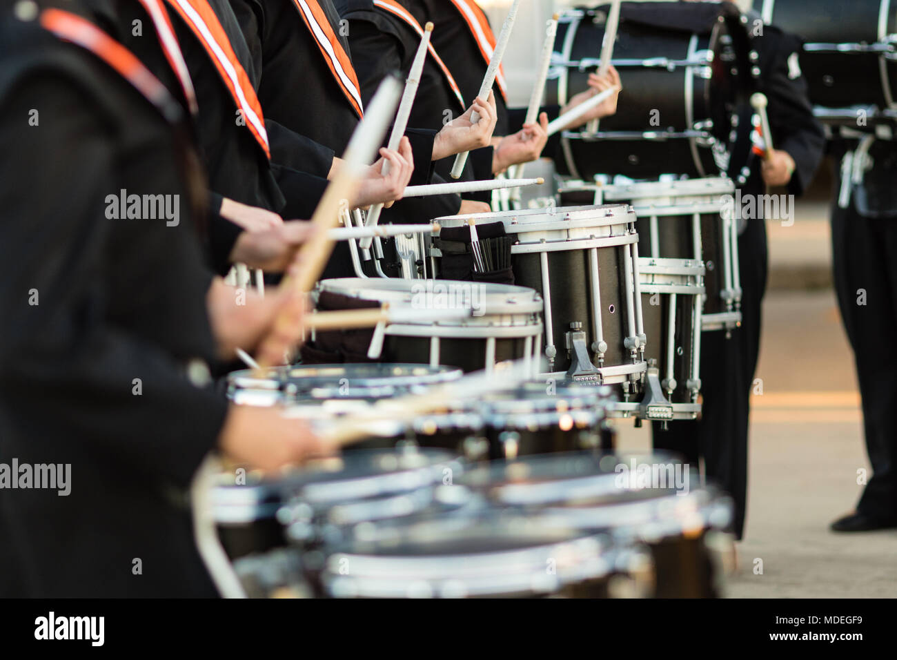 the drum sticks flashing as the drumline warms up Stock Photo