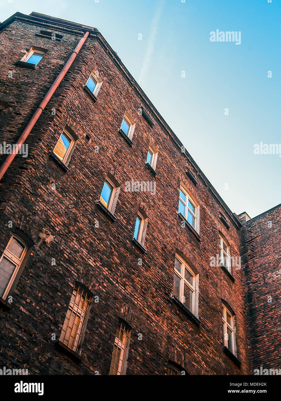 Zoom at the courtyard of an old red brick tenements house in the center of Katowice, Silesia, Poland. Stock Photo