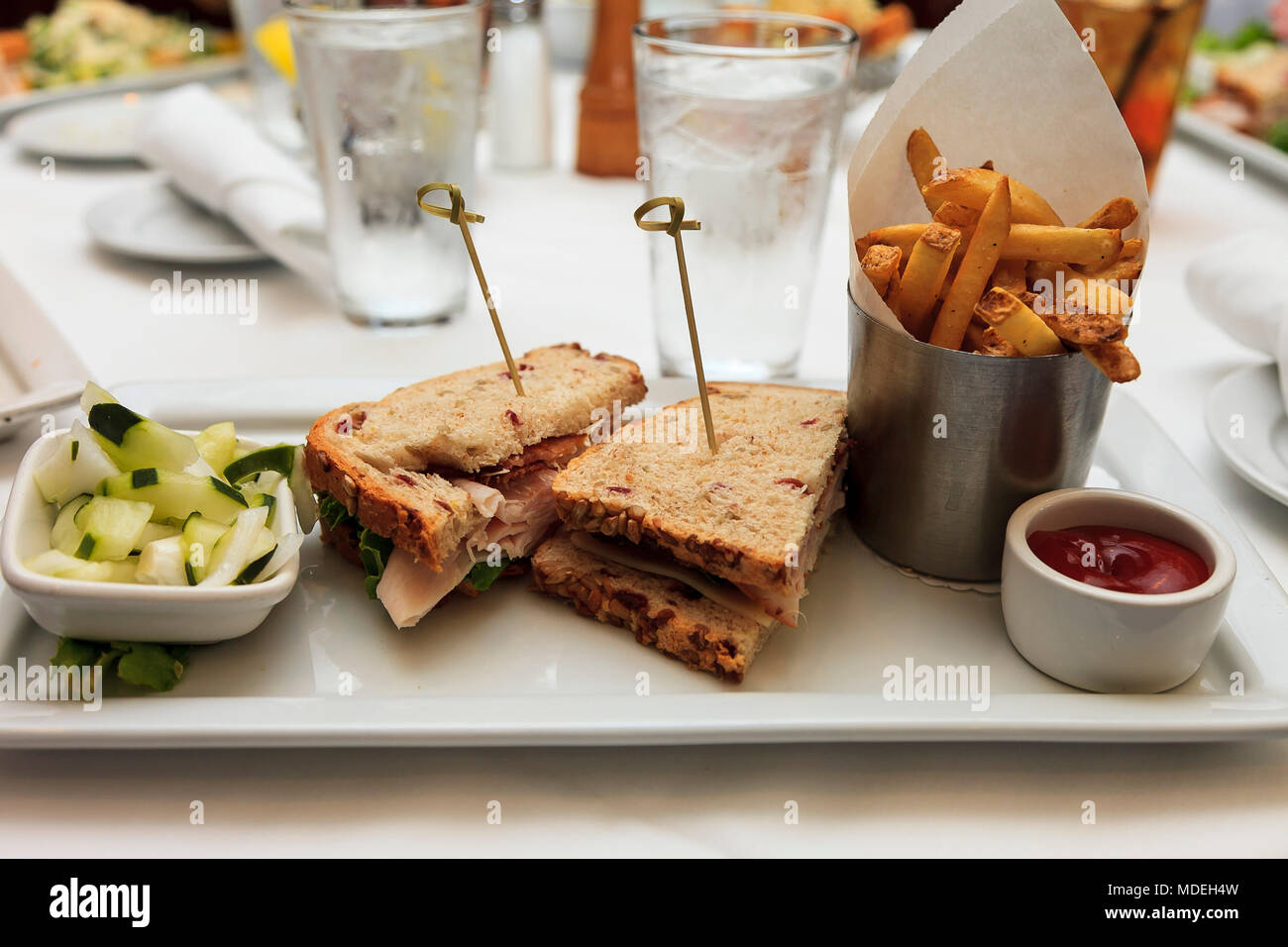 turkey club sandwich and french fries with friends Stock Photo