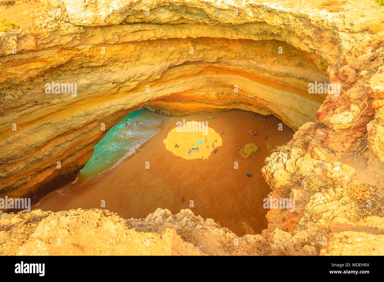 Aerial view of interior of Benagil Cave with sun's rays creating light effects, Lagoa in Algarve, Portugal, one of the most impressive sea caves in Europe. Algar de Benagil, is only acessible by sea. Stock Photo