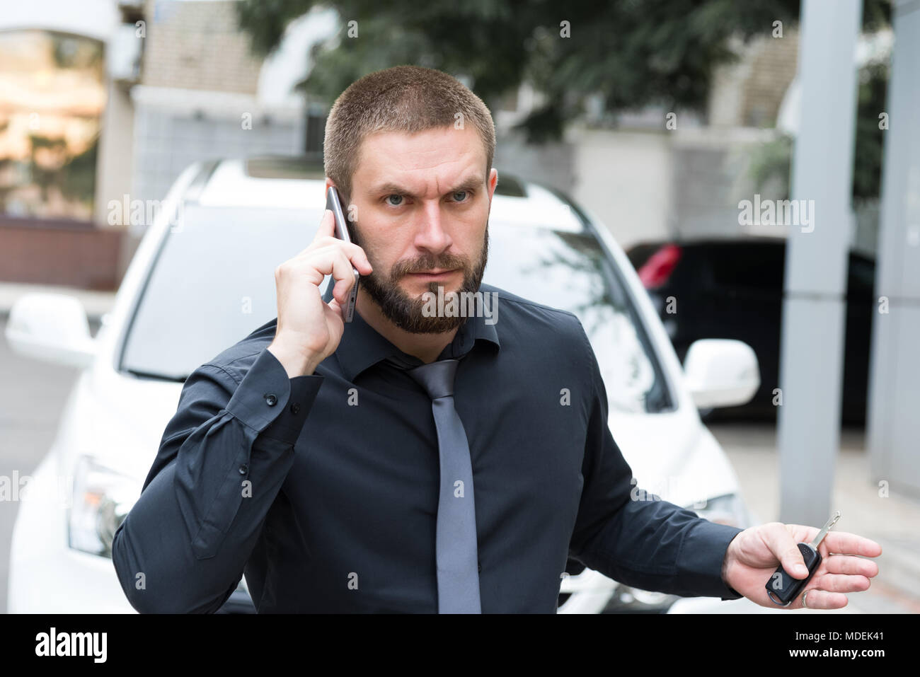 Man near the car talking on the phone Stock Photo
