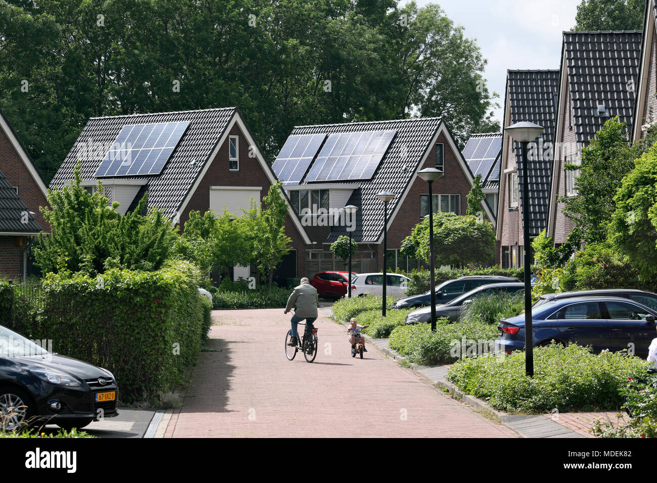 Dutch housing with solar photovoltaic cells on the roofs in Stad van de Zon (City of the Sun), a sustainable suburb of Heerhugowaard, North Holland. Stock Photo