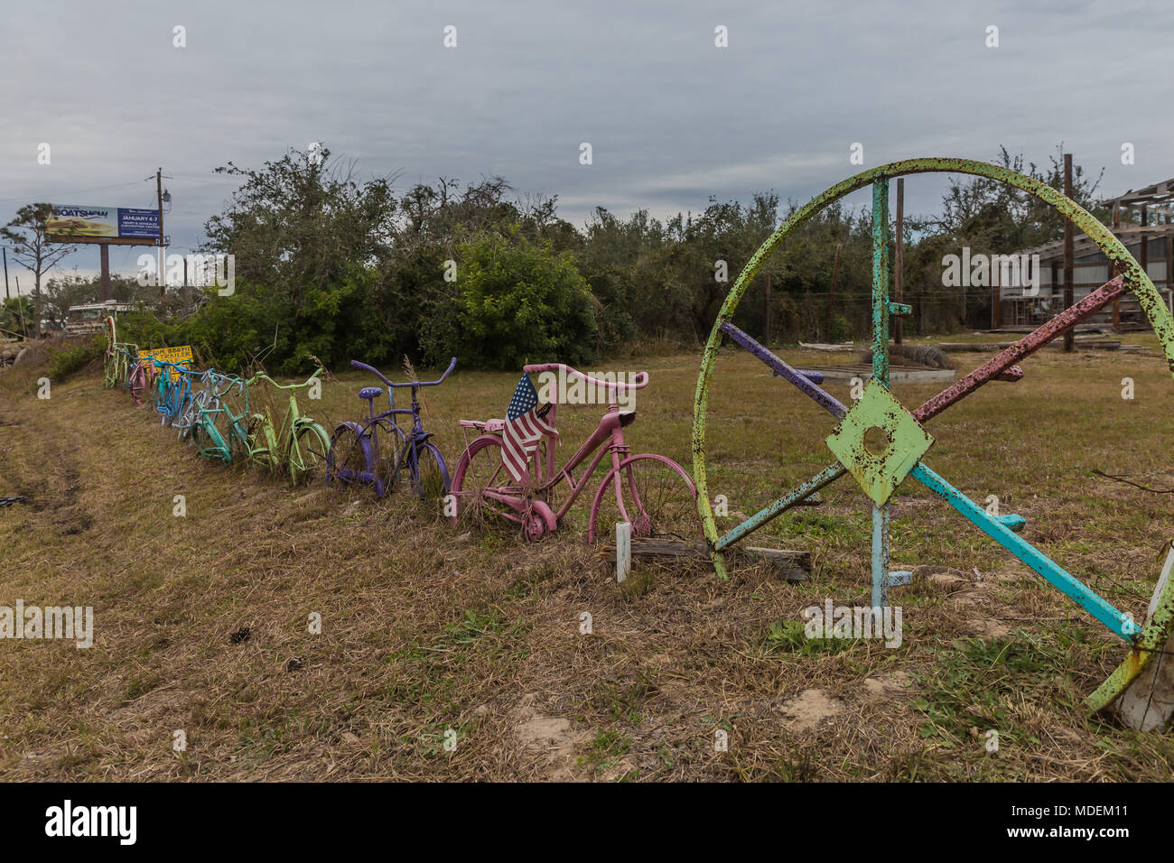 Color bicyles lined up to form a fence in Rockport Texas Stock Photo