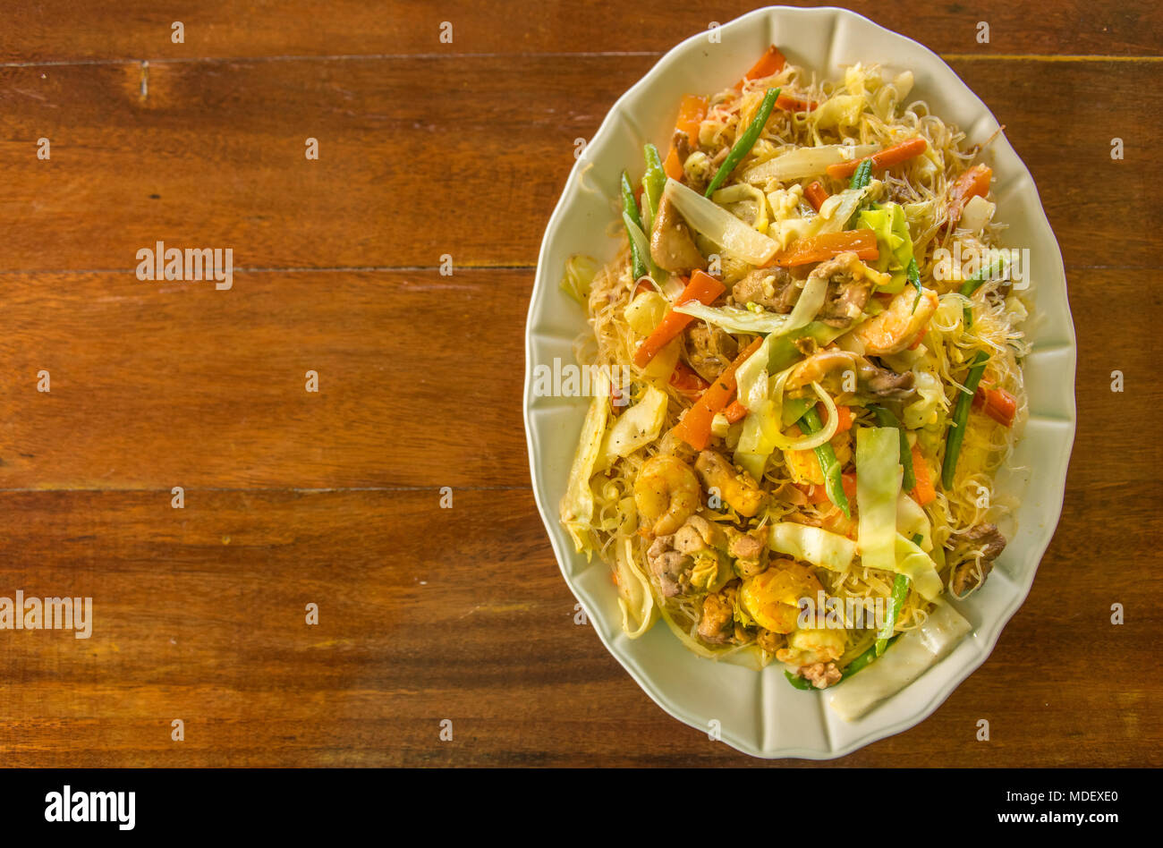 Fried Rice Noodles With Shrimp, Chicken and Vegetables Stock Photo