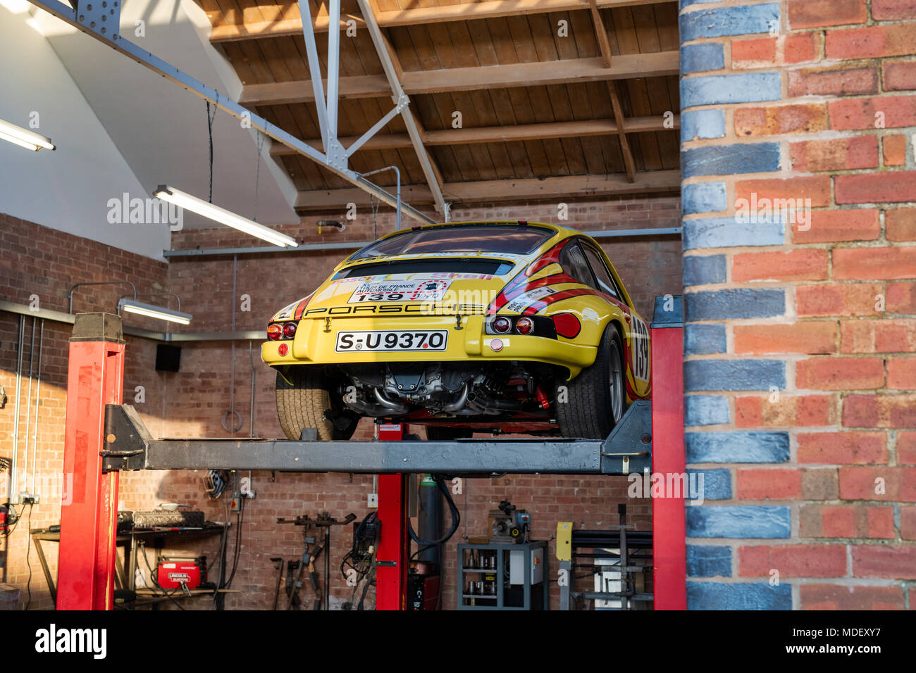 Racing porsche on a car ramp at Bicester heritage centre. Bicester, Oxfordshire, England Stock Photo