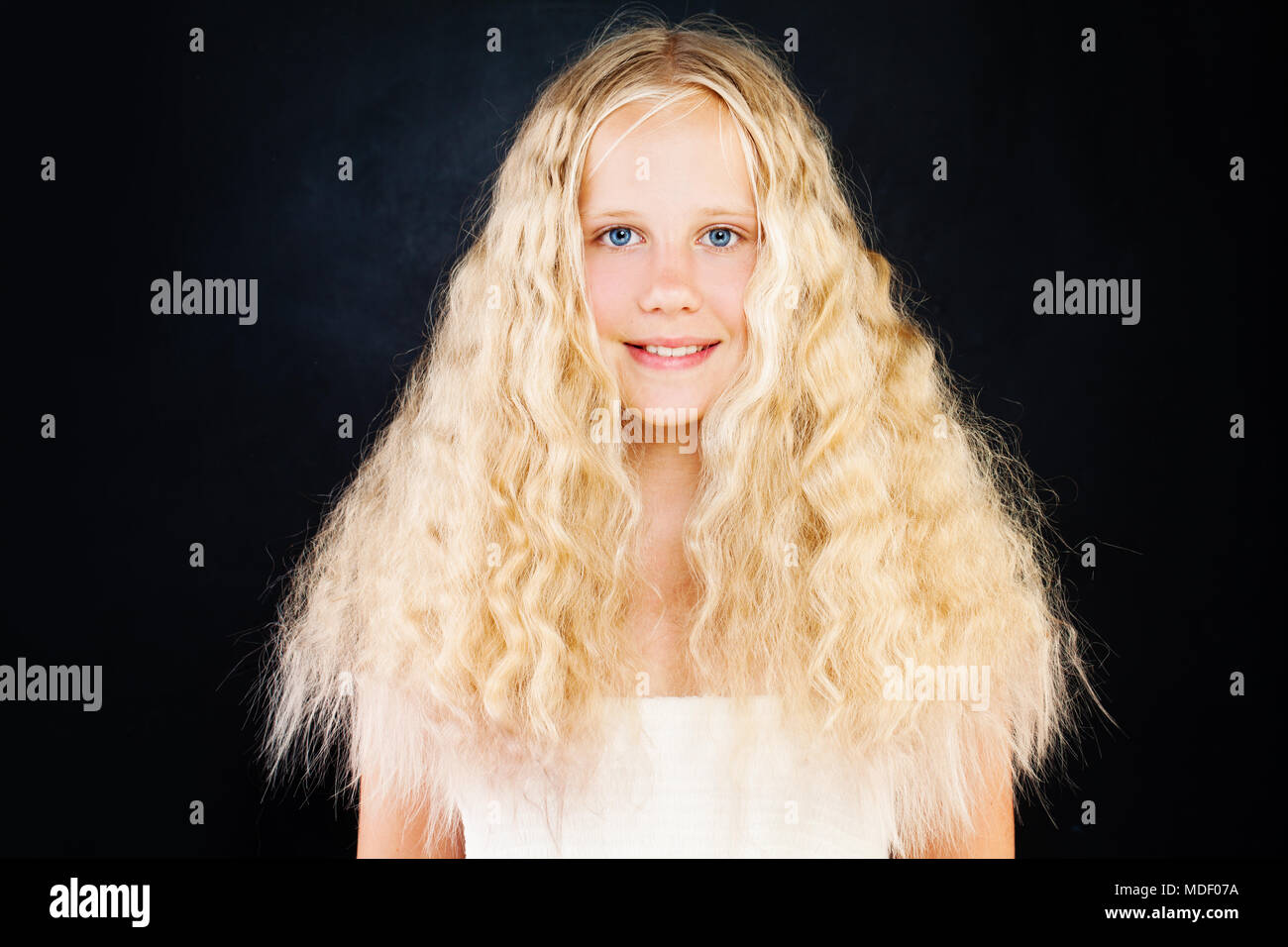 Cute Young Girl with Blonde Curly Hair. Blonde Teen Girl with Curly Hair on  Dark Background Stock Photo - Alamy