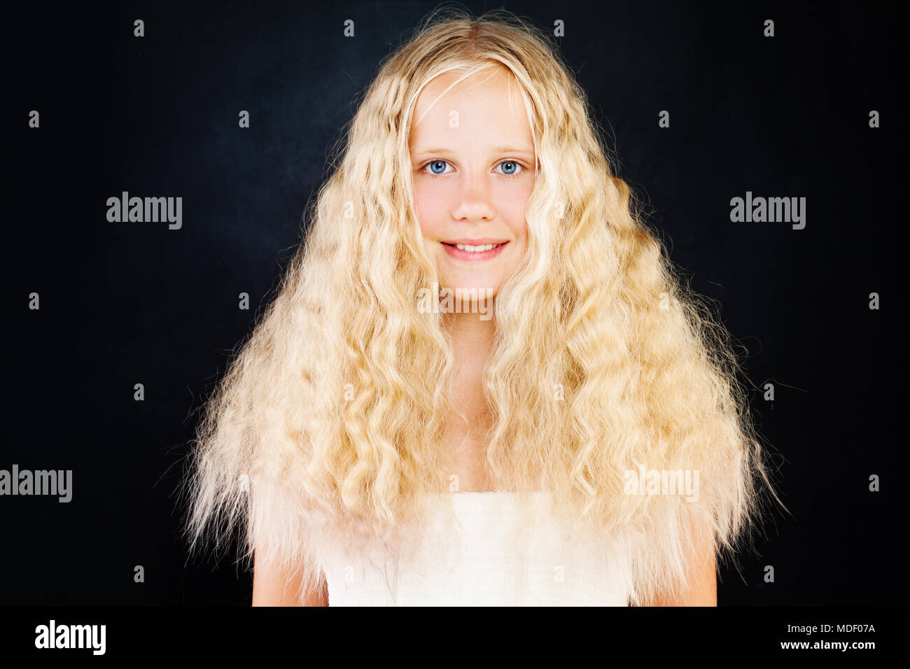 Cute Young Girl With Blonde Curly Hair Blonde Teen Girl With Curly Hair On Dark Background Stock Photo Alamy