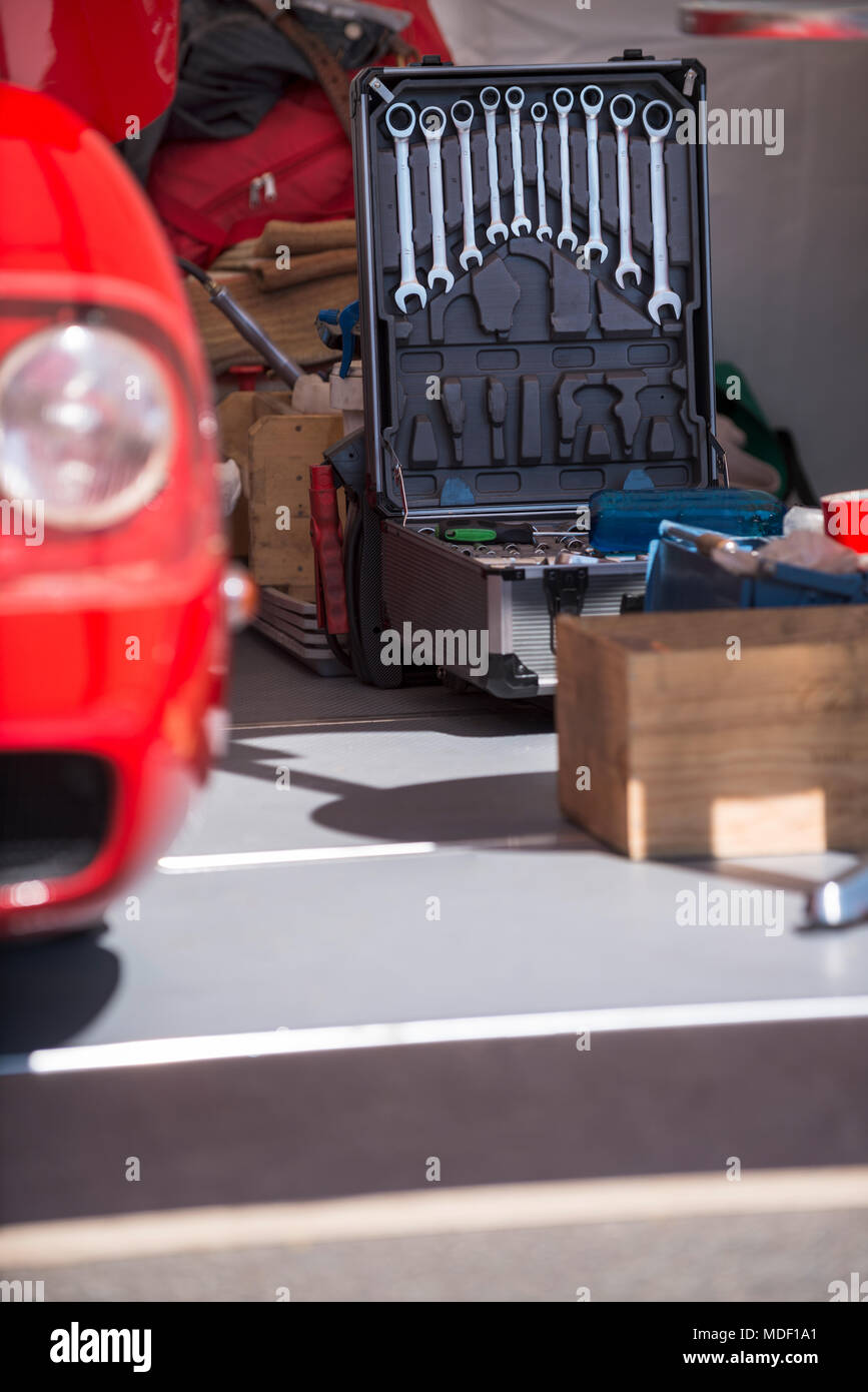 classic car with tools and spare parts in an open garage Stock Photo