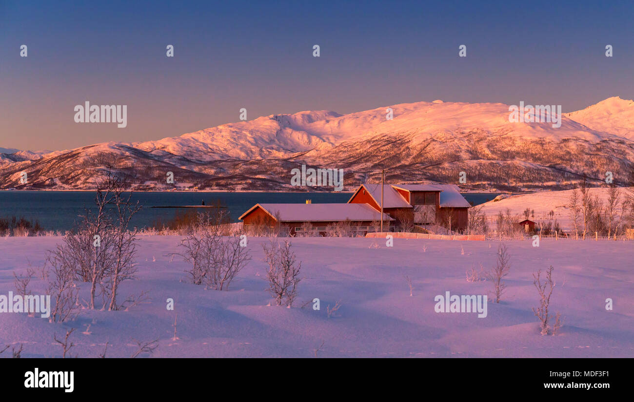 View of a Norwegian farm on the North Norwegian coast in Winter at Sunset. Stock Photo
