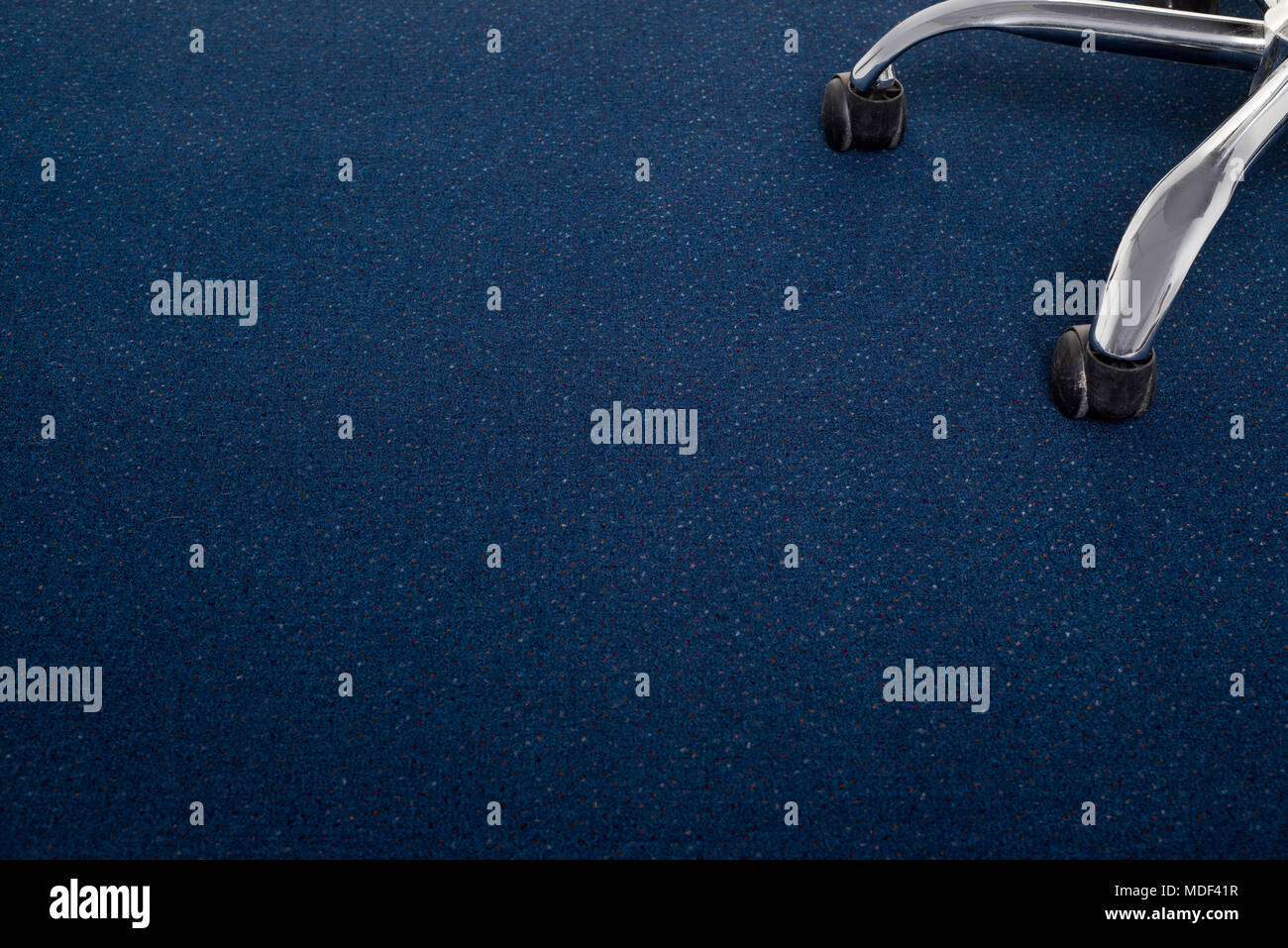 Office chair on blue carpet Stock Photo Alamy