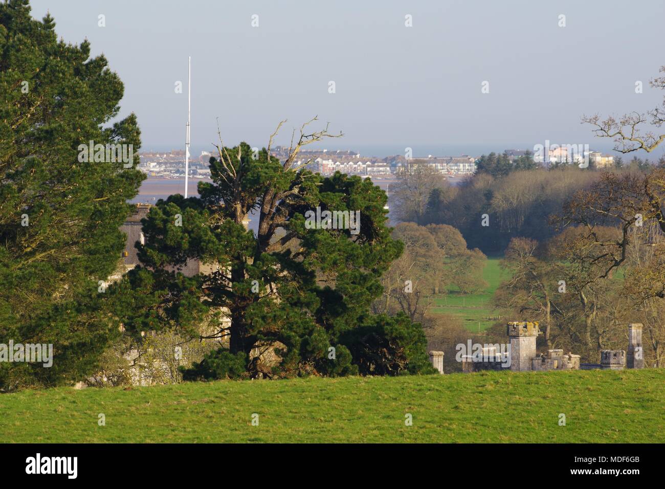 Uppermost Stone Turrets Of Powderham Castle Among Parkland And uppermost-stone-turrets-of-powderham-castle-among-parkland-and