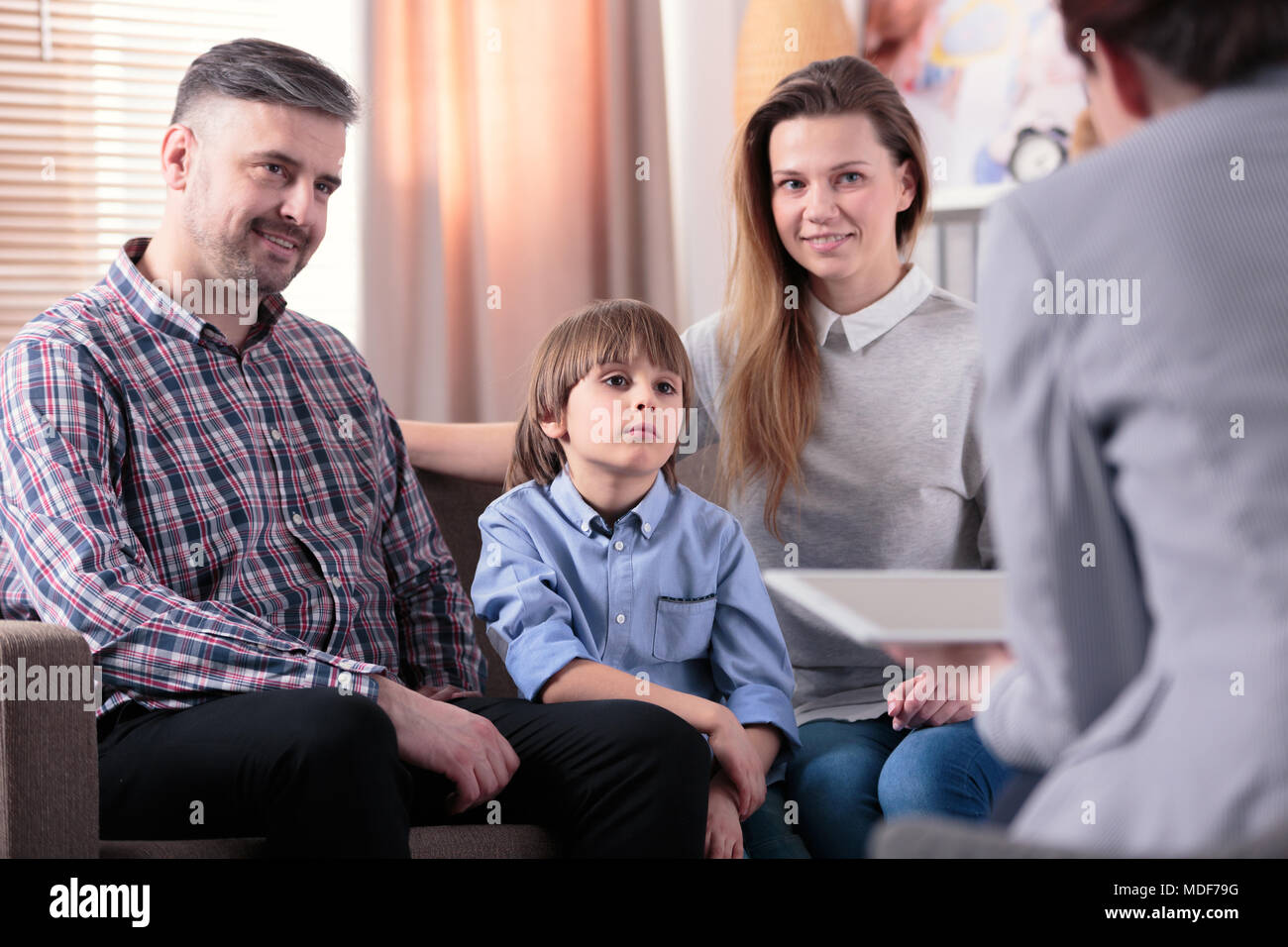 Happy marriage with their son during a meeting with counselor Stock Photo