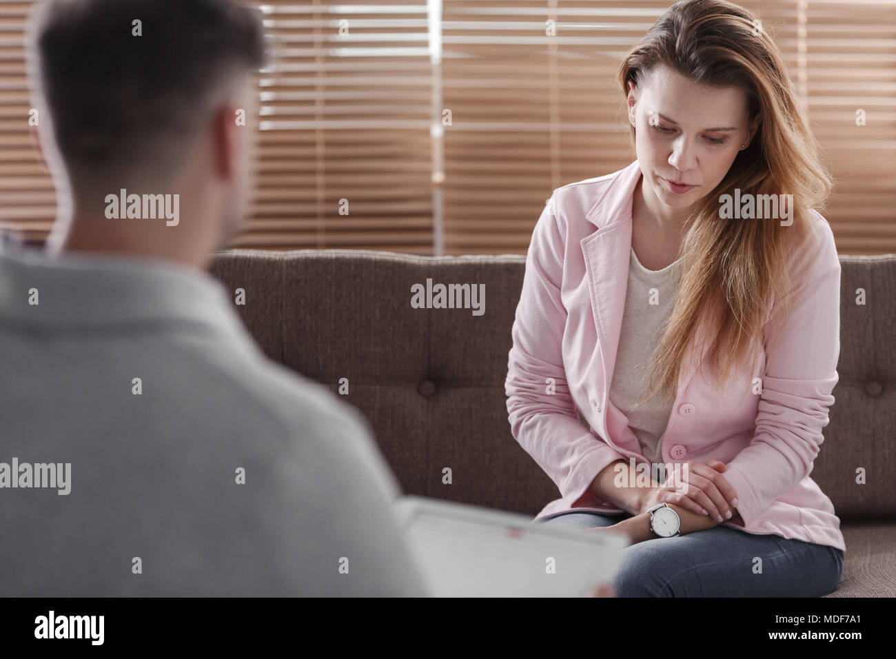 Depressed woman talking to an advisor about a divorce Stock Photo