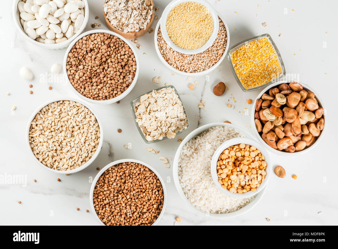 Selection various types cereal grains groats in different bowl on white