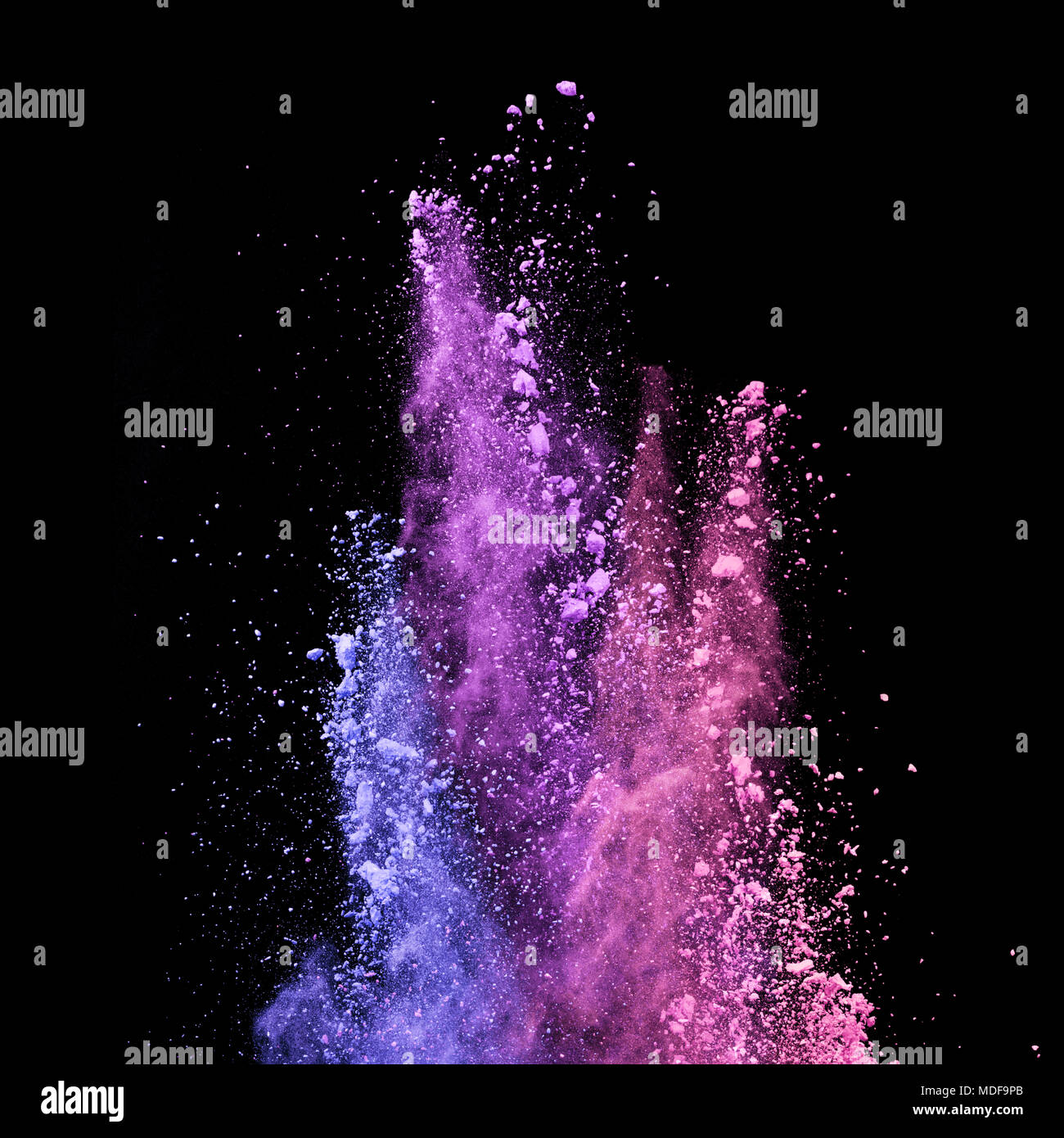 Abstract colored powder explosion isolated on black background. High ...