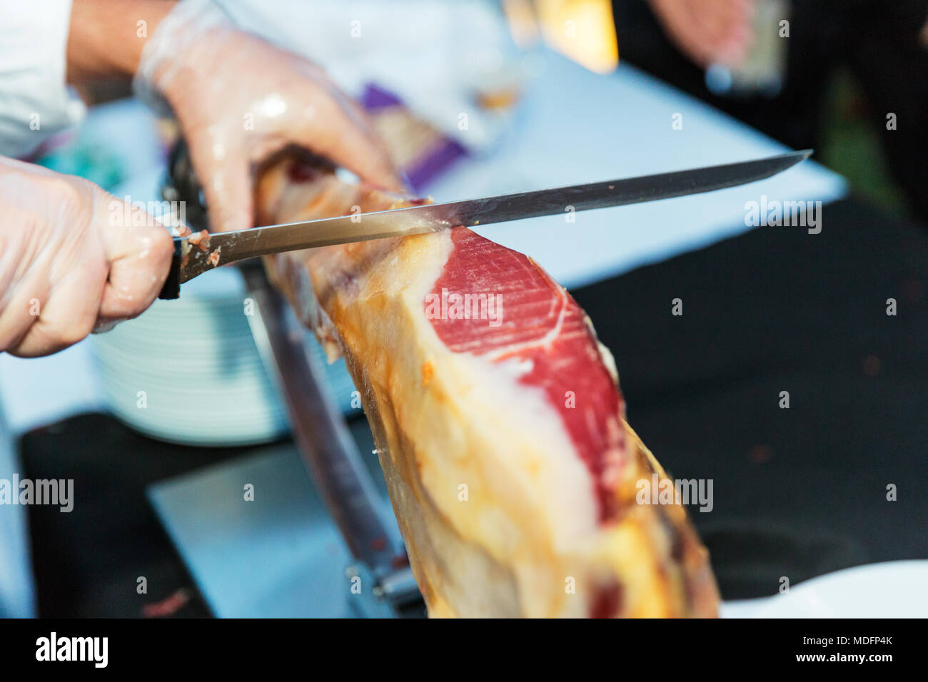 Man slicing a jamon iberico de bellota Stock Photo