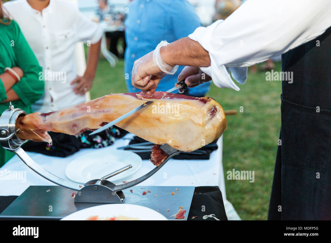 Man slicing a jamon iberico de bellota Stock Photo