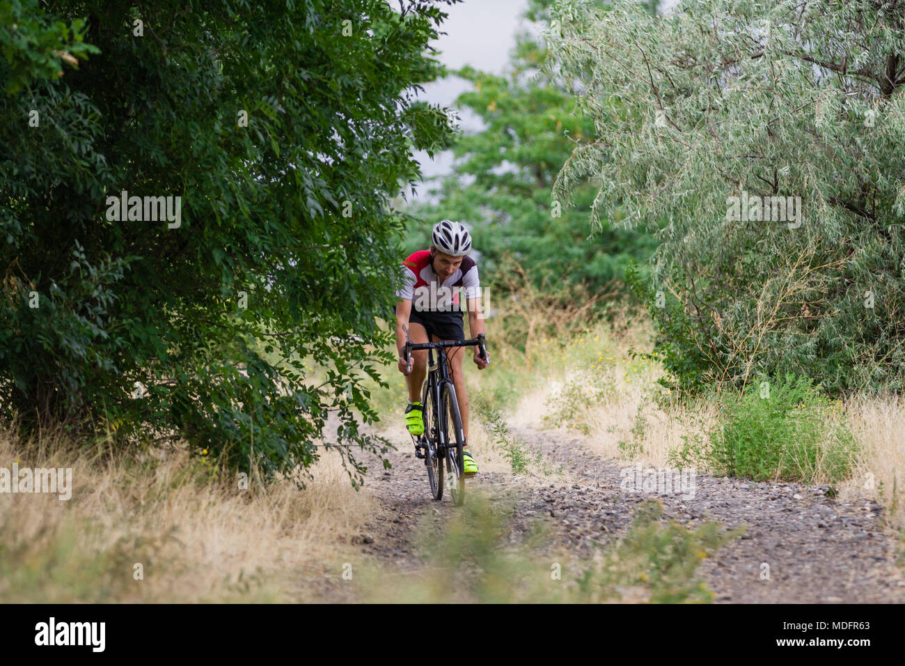 Professional cyclist training offroad riding in fields, bicycle rider