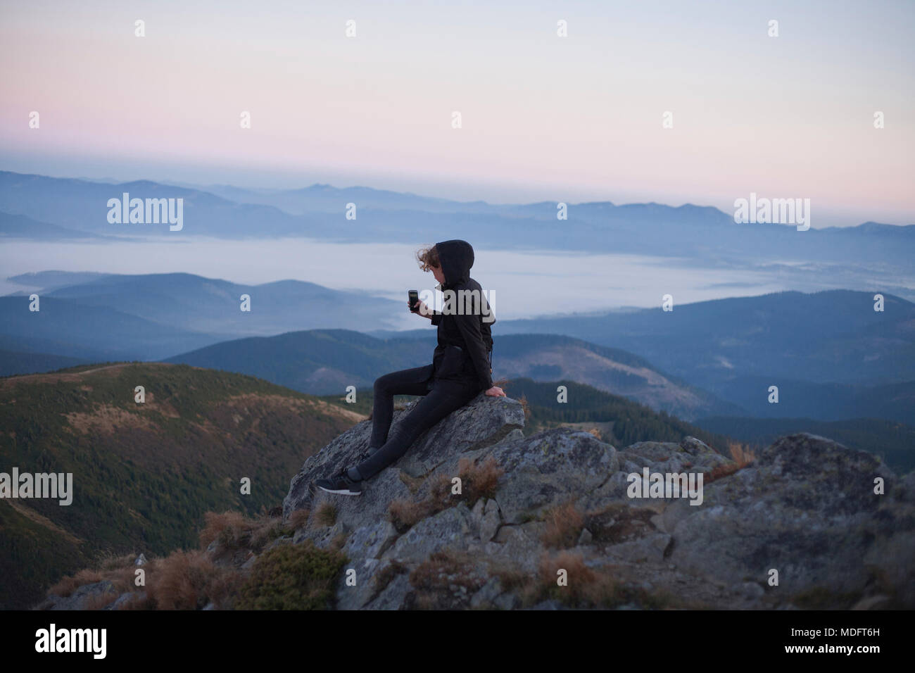Woman taking a photo of Carpathian mountain view, Ukraine Stock Photo