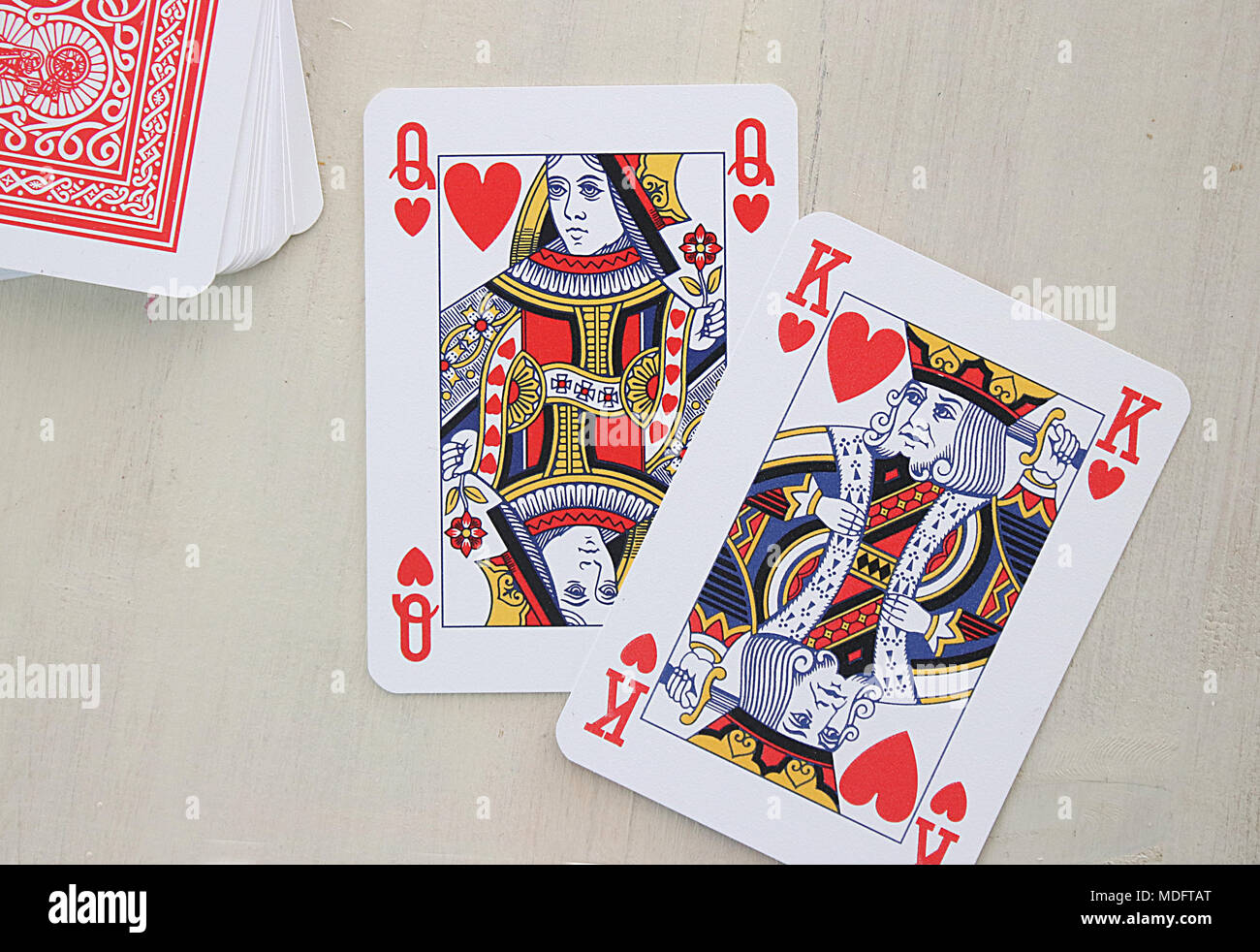 King and queen of hearts and a stack of playing cards Stock Photo
