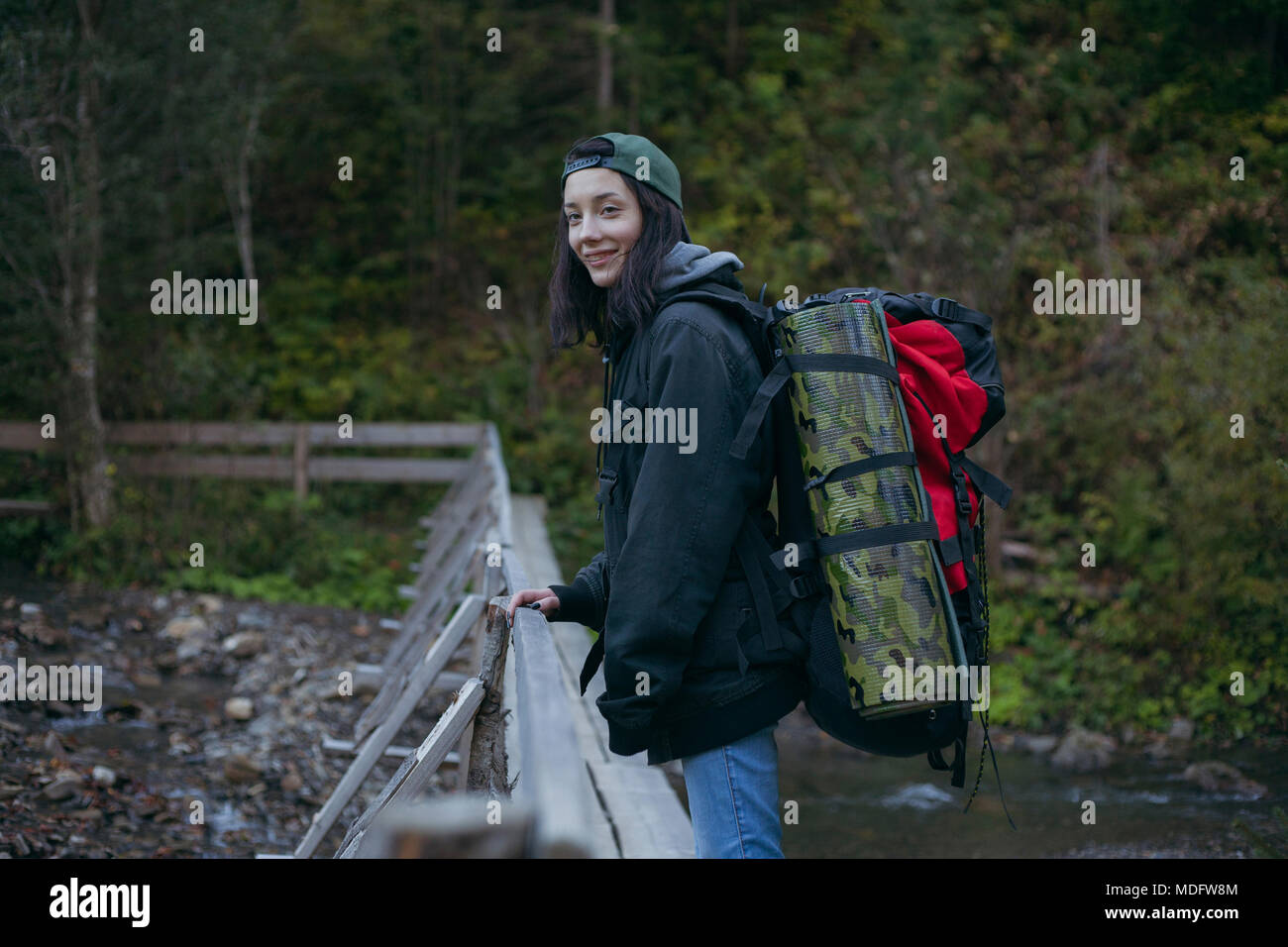 Female hiker standing on a bridge, Ukraine Stock Photo
