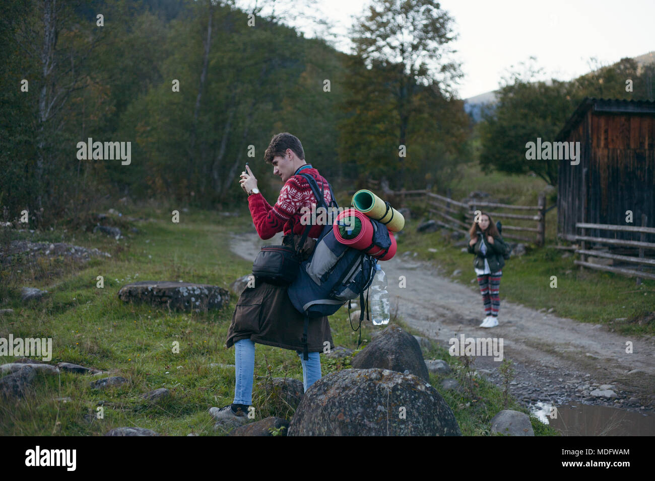 Two backpackers taking photos, Ukraine Stock Photo