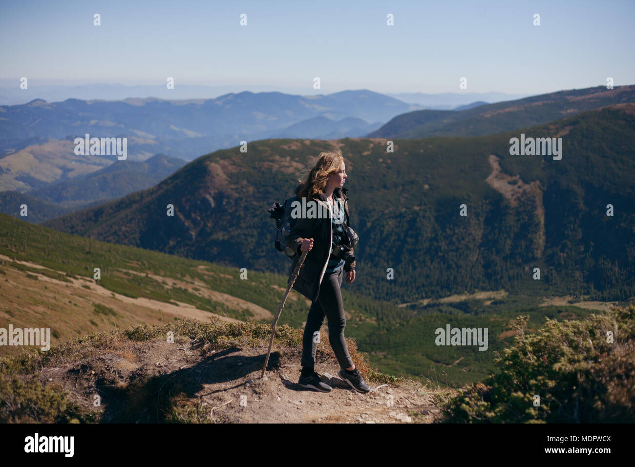 Female hiker standing in mountains looking at view, Ukraine Stock Photo