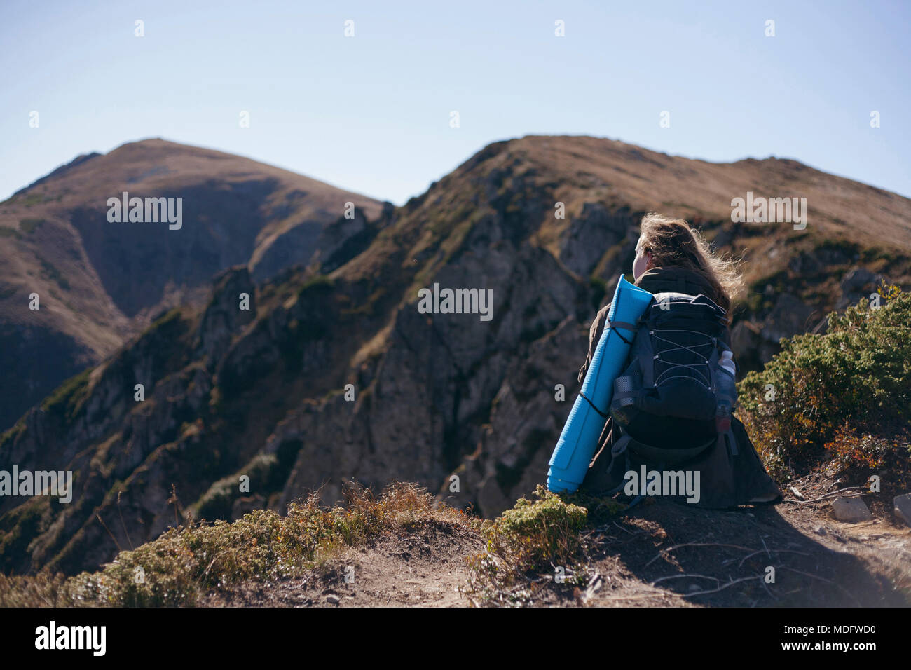 Woman sitting on a mountain looking at view, Ukraine Stock Photo