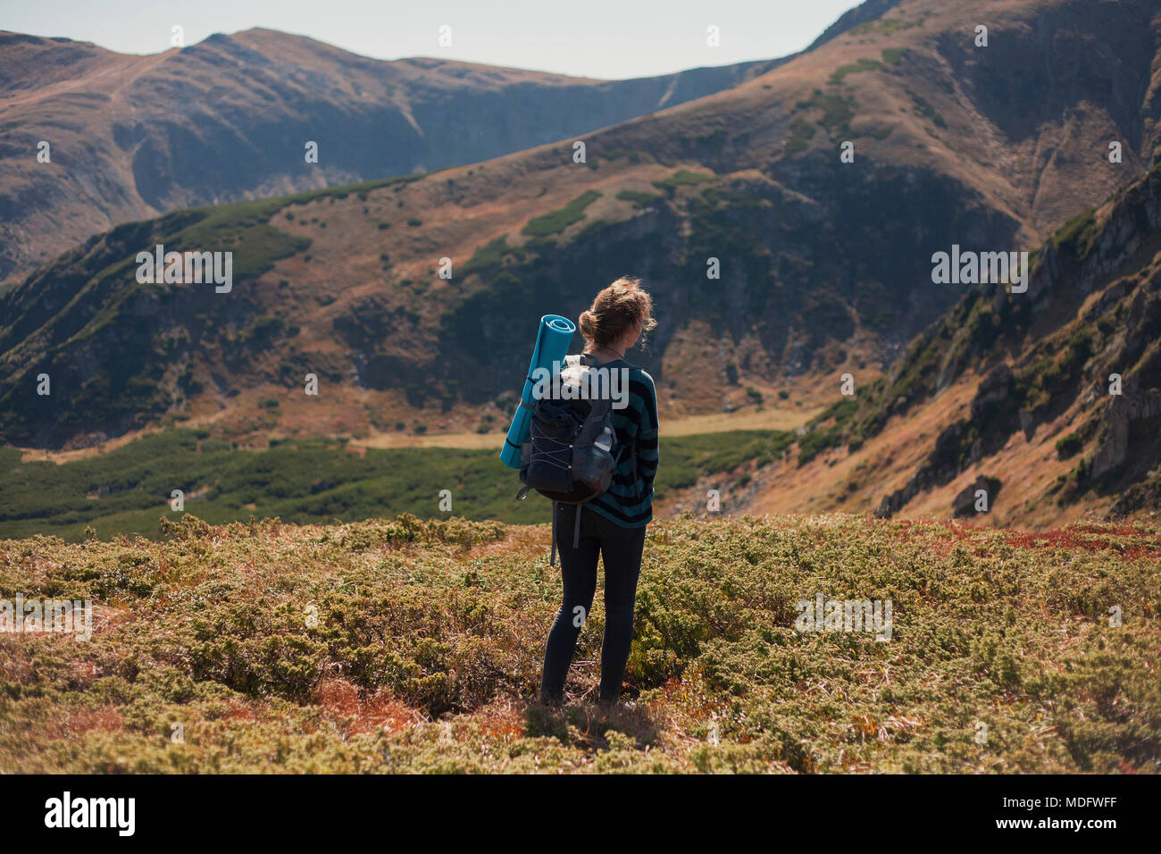 Woman standing in mountains looking at view, Ukraine Stock Photo