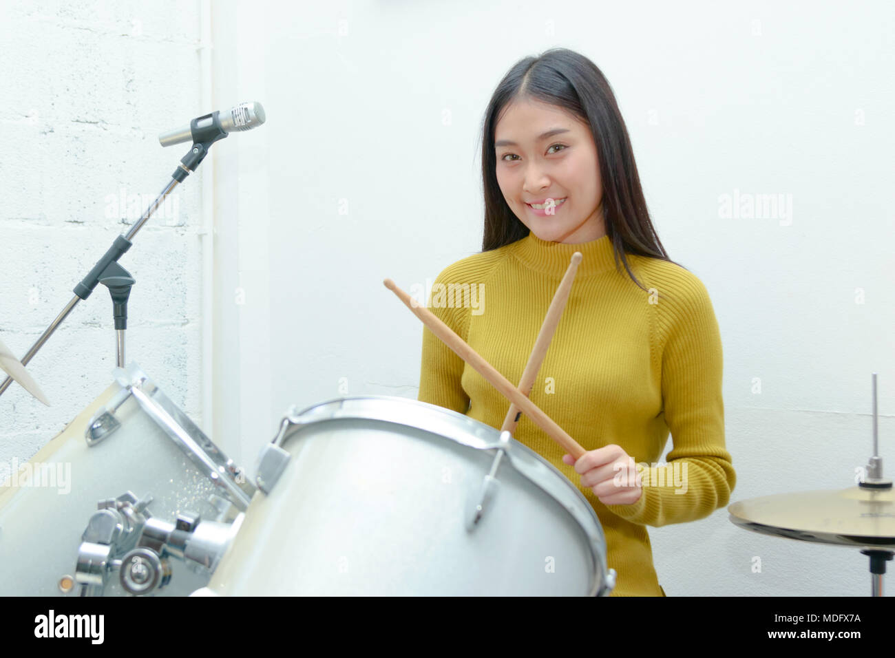 Teenage girl playing drums hires stock photography and images Alamy