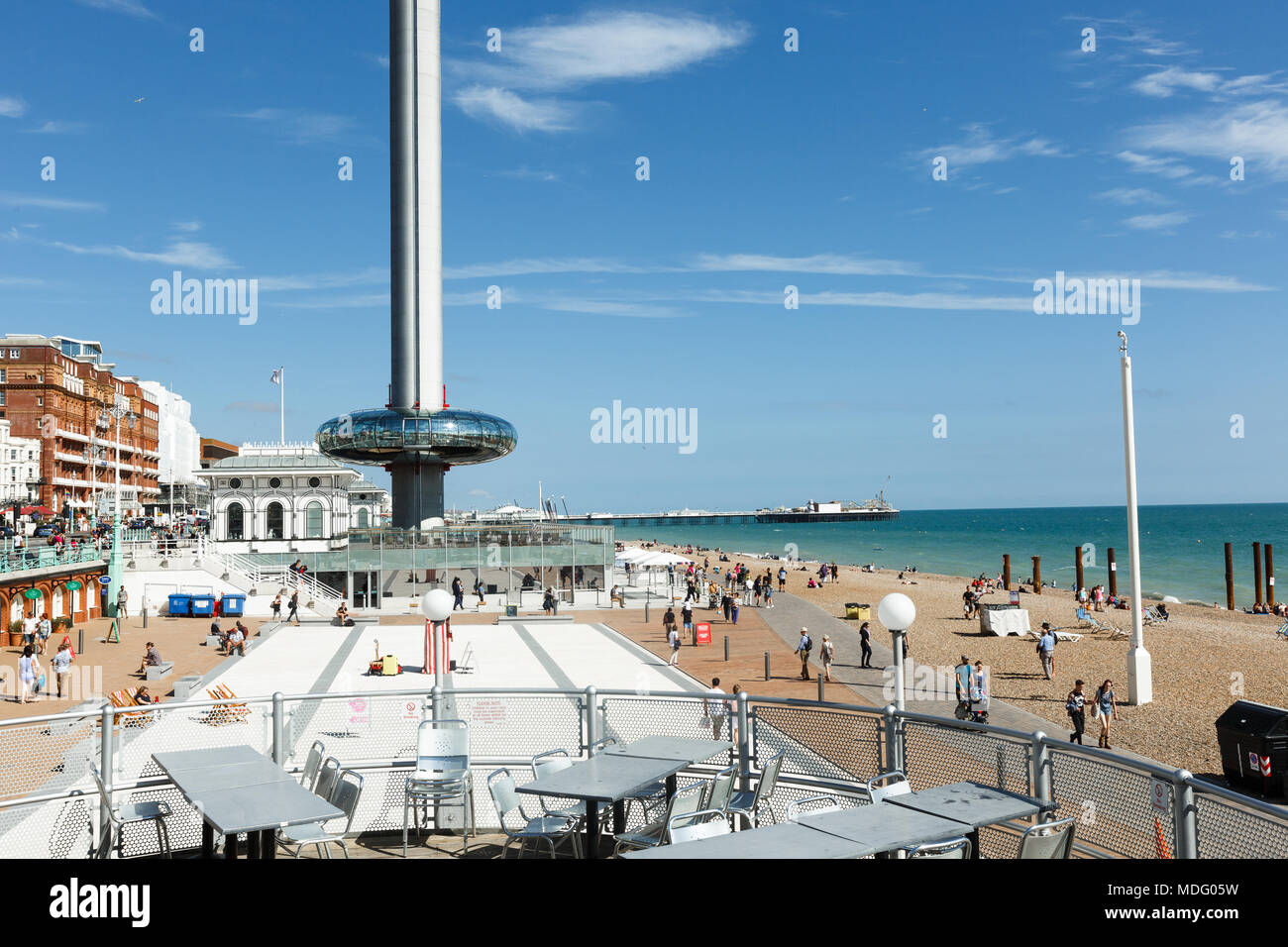 People admire walking on Brighton costline, view of English channel, tower i360 Stock Photo