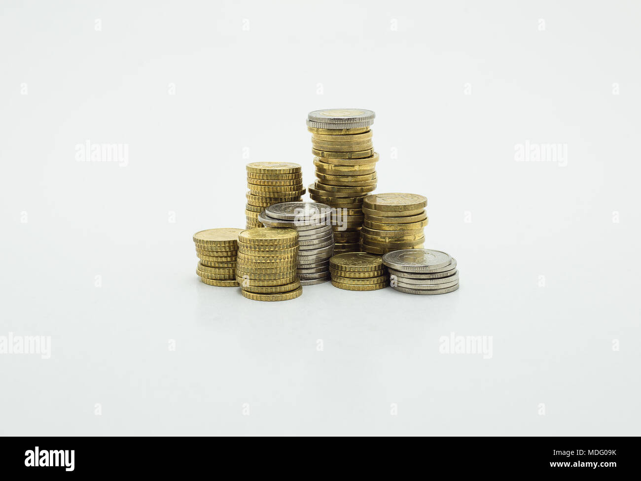 Stack of gold and silver coins isolated on white background with ...