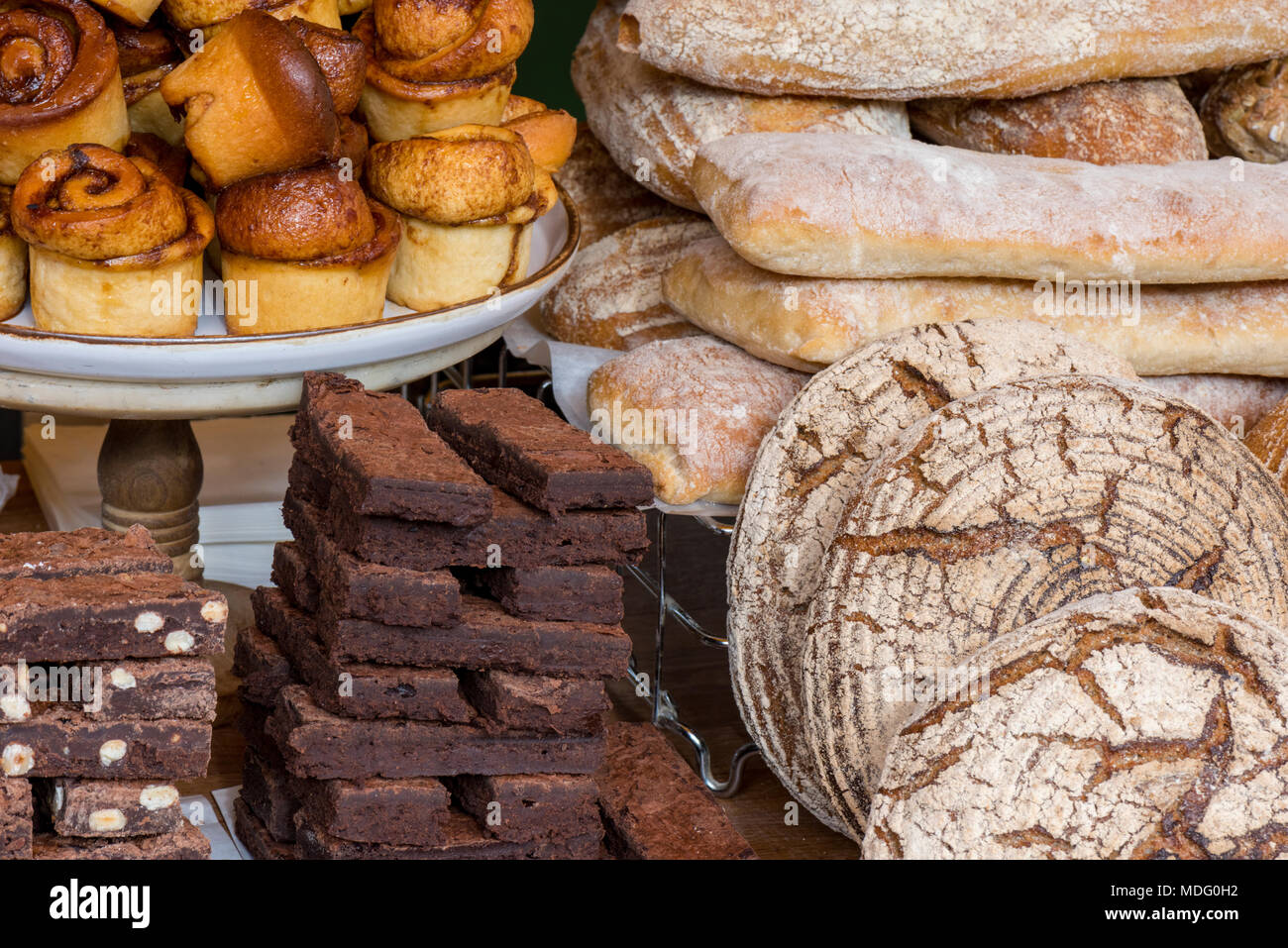 a selection of cakes and baked products at an artisan bakery stall or bakers on borough market in central london. artisan bakeries selling a selection Stock Photo