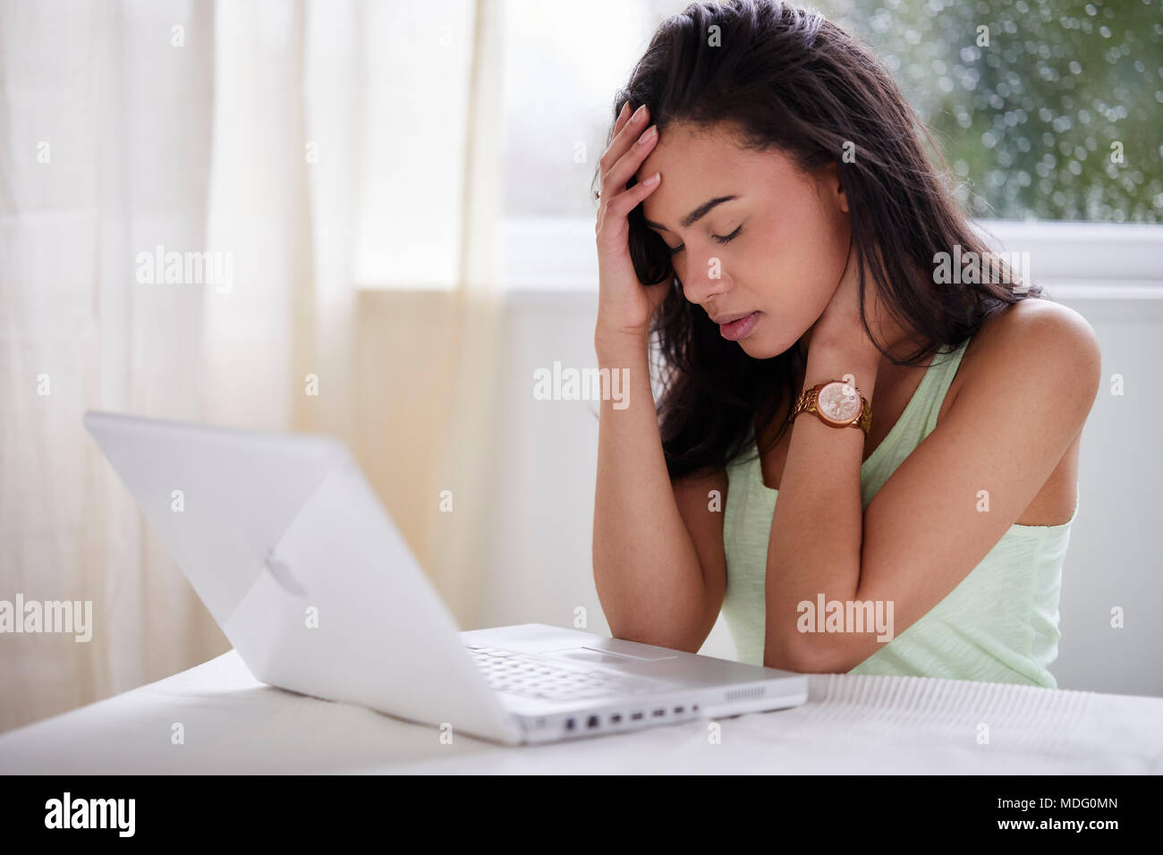Stressed out girl using laptop Stock Photo - Alamy