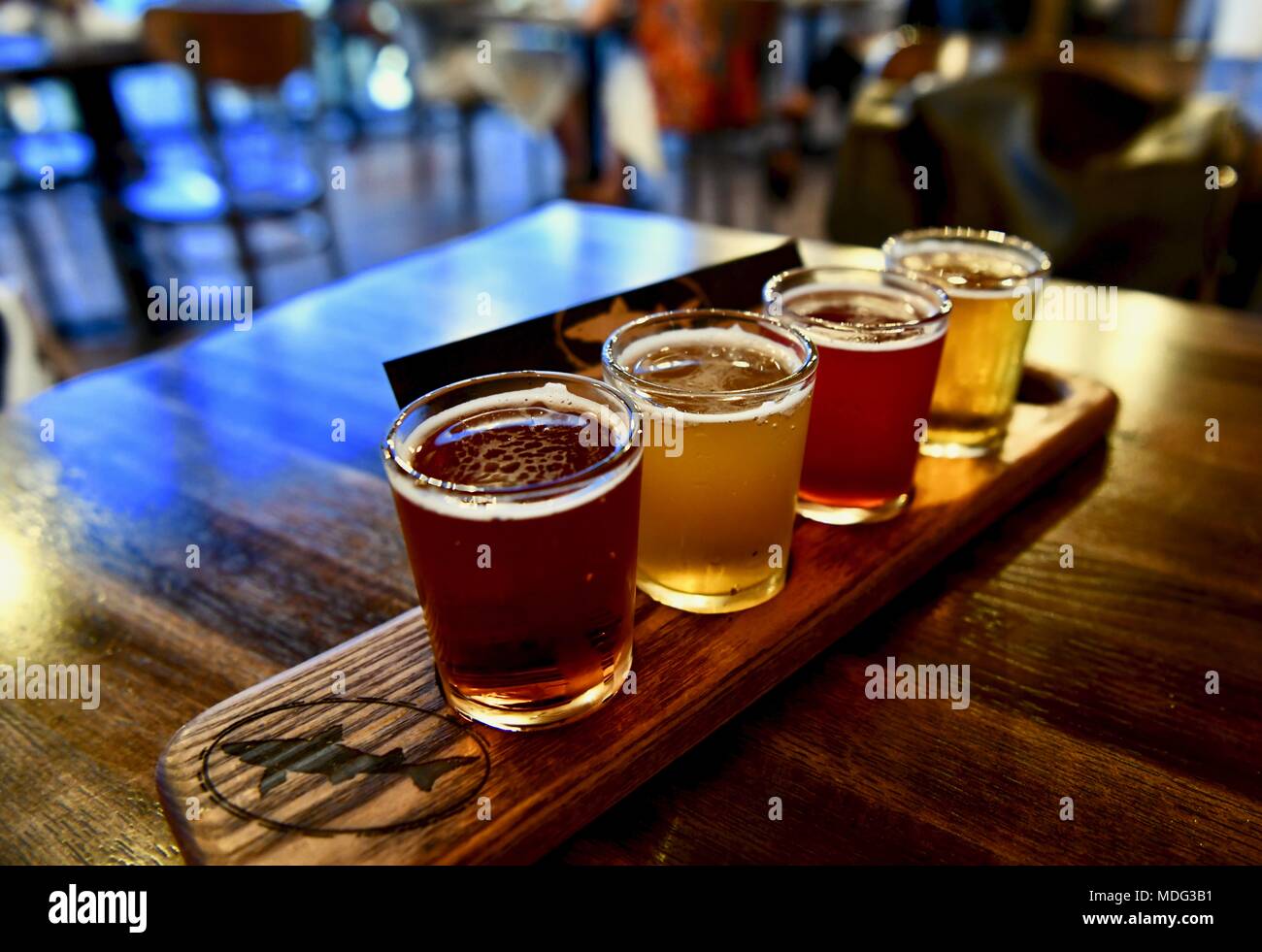 Beer flight sampler container an IPA, pale ale, Hefeweizen, and a lager