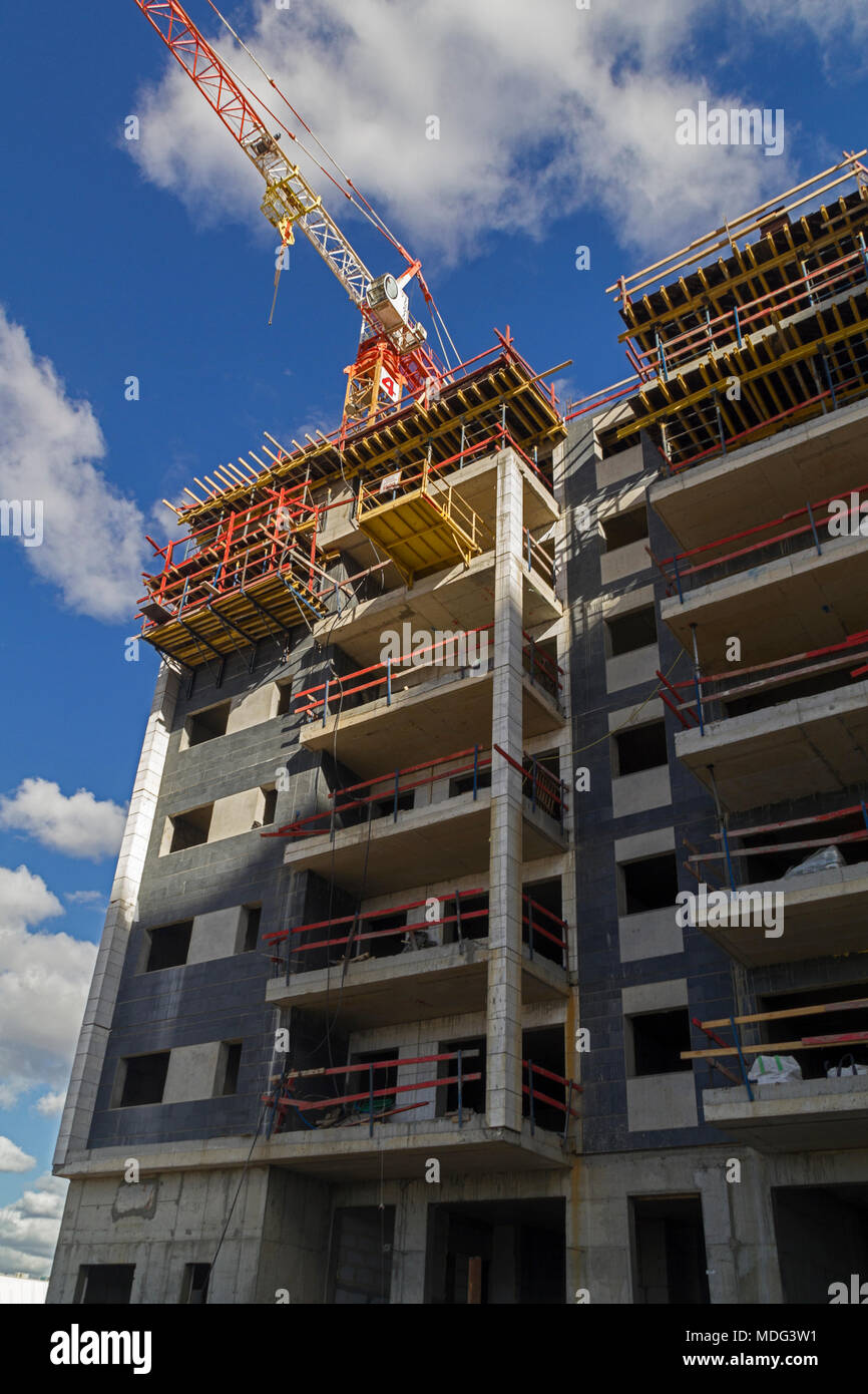 New residential building with hgh rise tower crane construction site ...