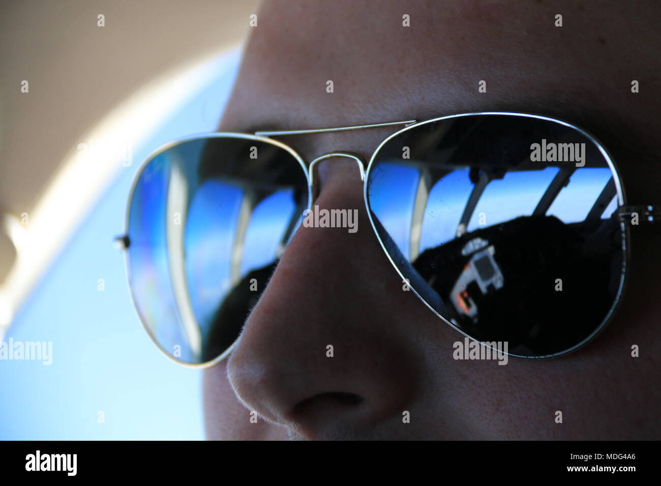 Flight deck reflecting in the pilot's sunglasses Stock Photo