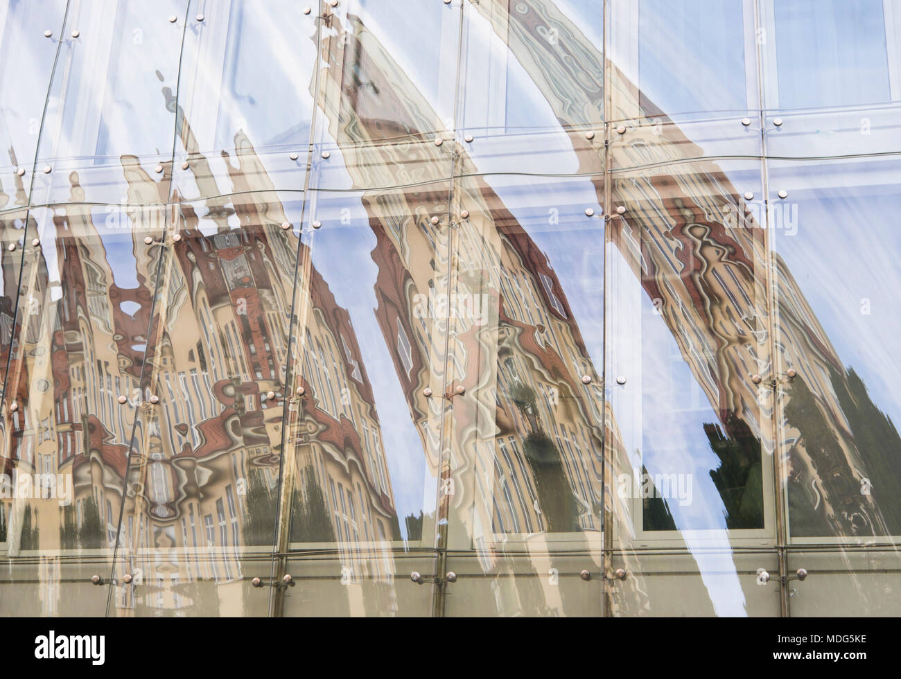 Curved almost abstract building reflection in glass facade Bohaterów Monte Cassino street, in the holiday resort town of Sopot Poland near Gdansk Stock Photo