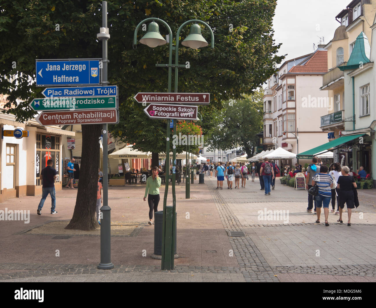 Information signs and holidaymakers on Bohaterów Monte Cassino street in the holiday resort town of Sopot Poland near Gdansk on the Baltic coast Stock Photo